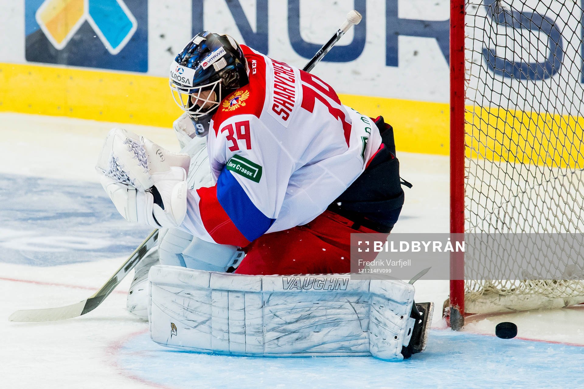 The puck gets past goaltender Aleksandr Sharychenkov of