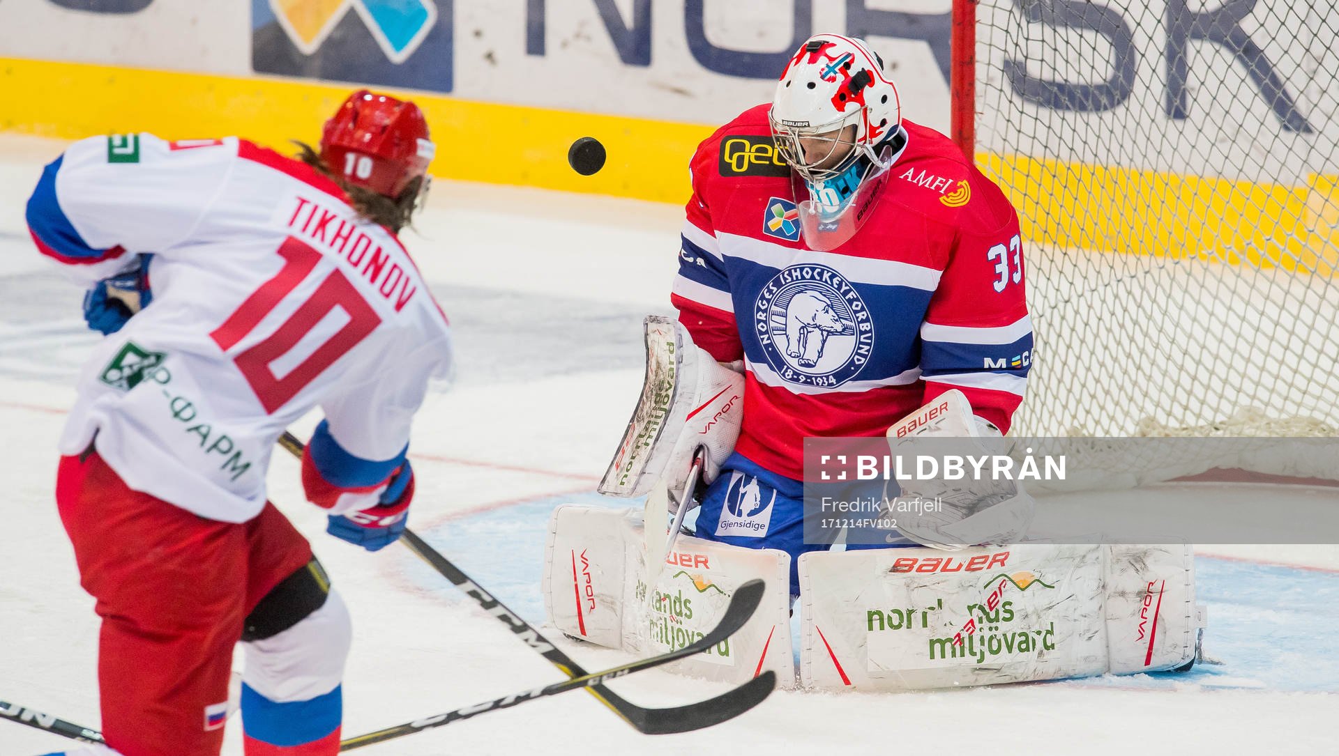 Viktor Tikhonov of Russia and Goaltender Henrik Haukeland