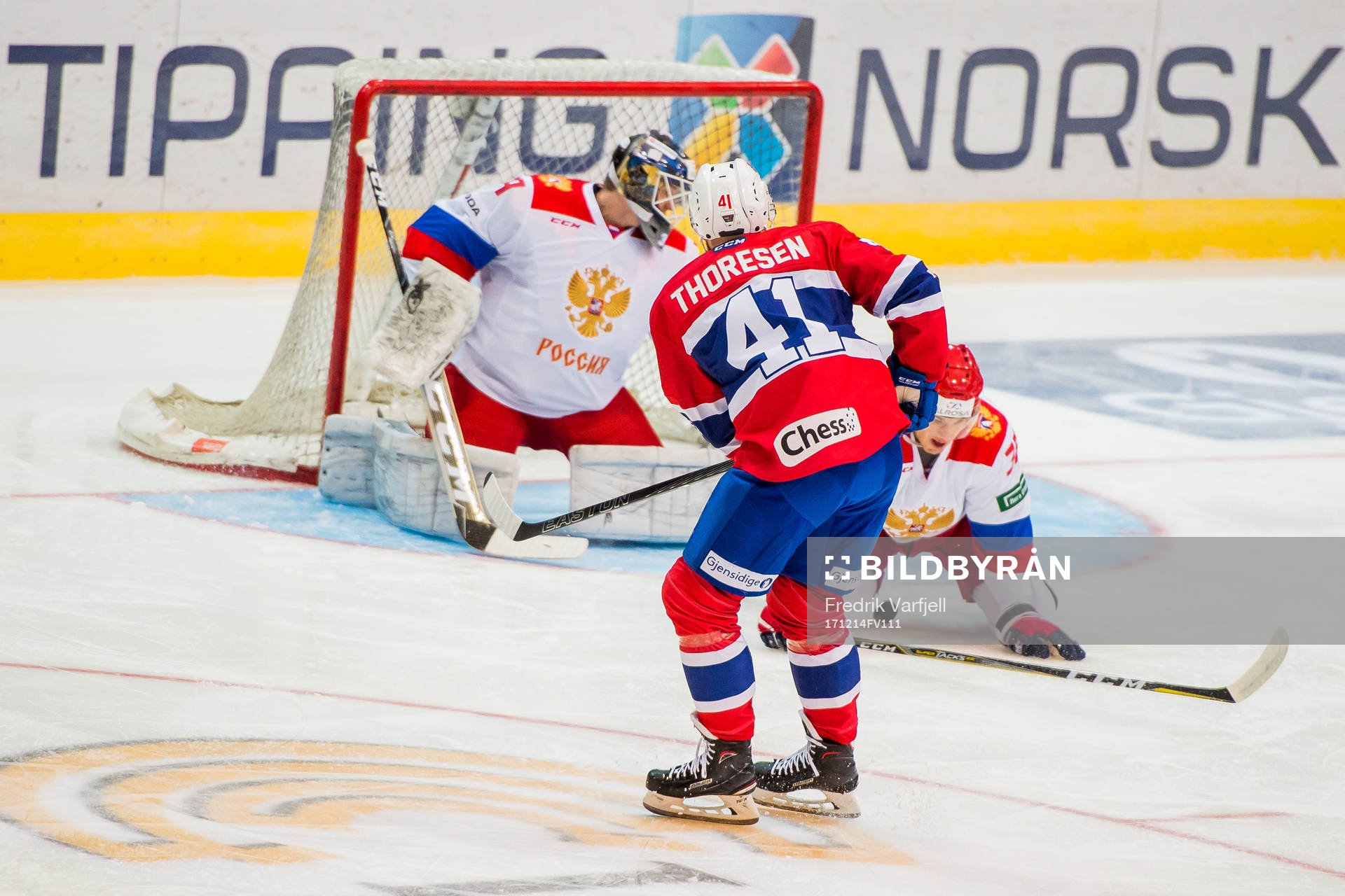 Patrick Thoresen of Norway scores 1-0 behind goaltender