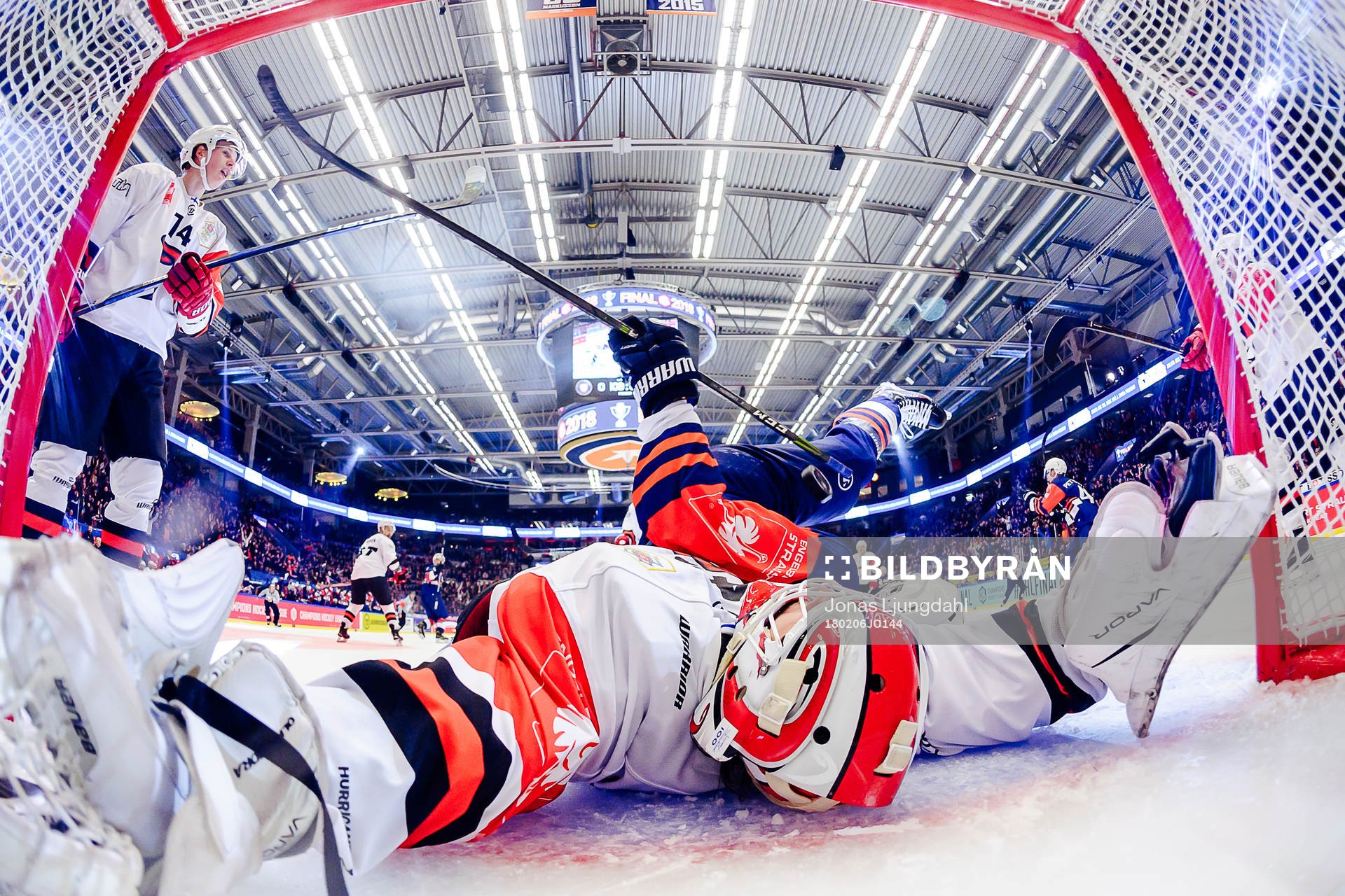 Martin Lundberg of Växjö falls into goals Juho Olkinuora