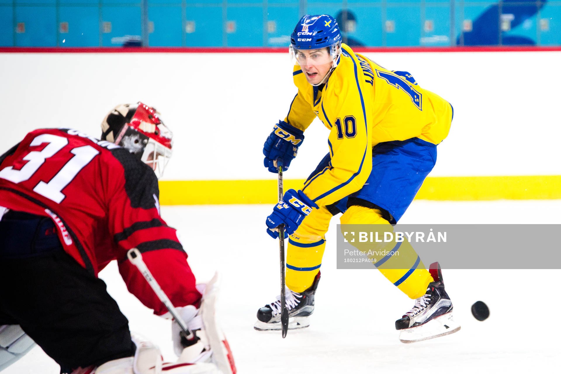 Joakim Lindström of Sweden against Goaltender Kevin Poulin