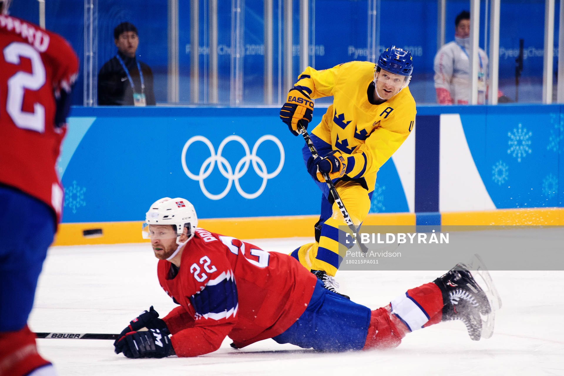 Staffan Kronwall of Sweden shoots while Martin Røymark of