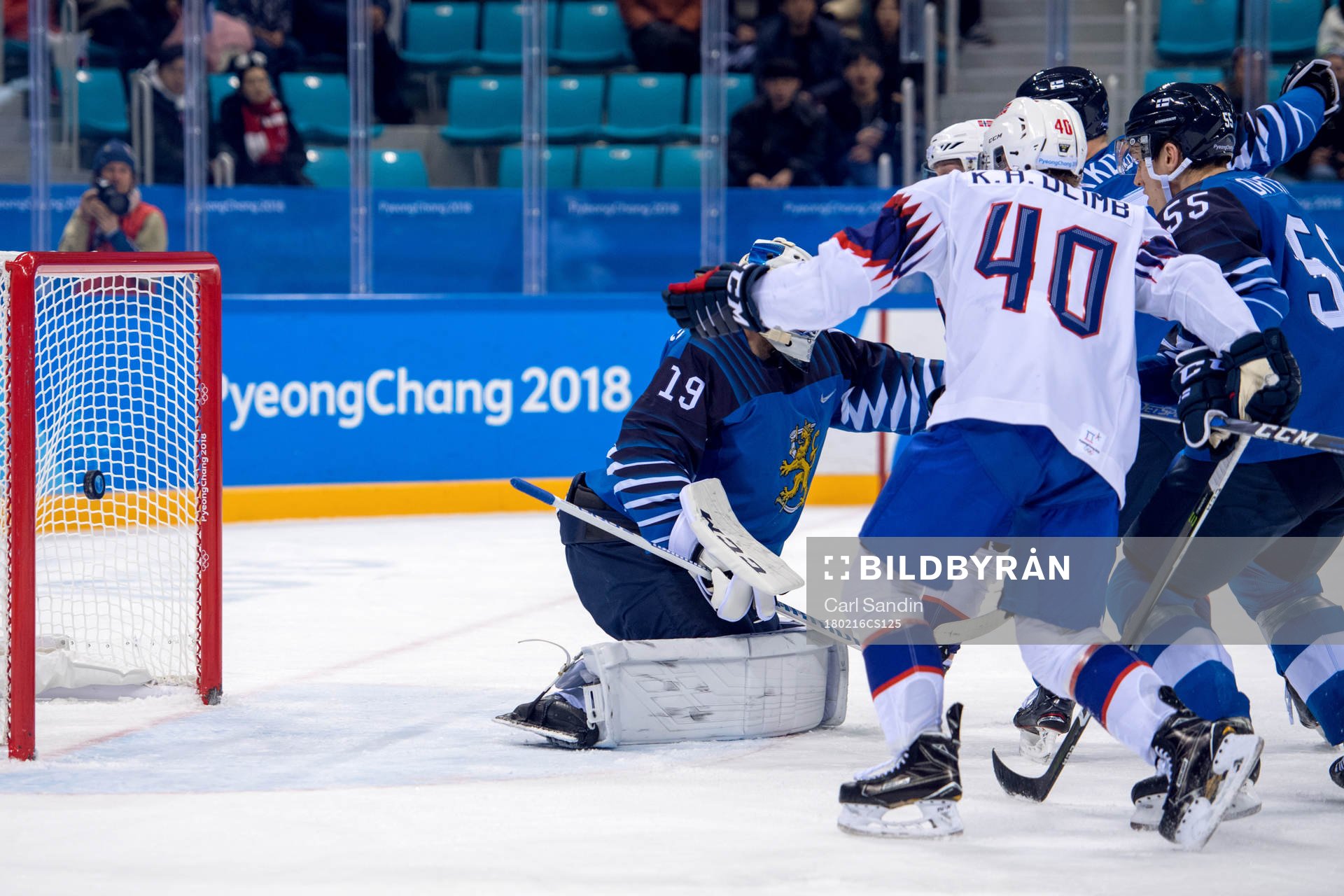 The puck hits the bar behind Goaltender Mikko Koskinen of