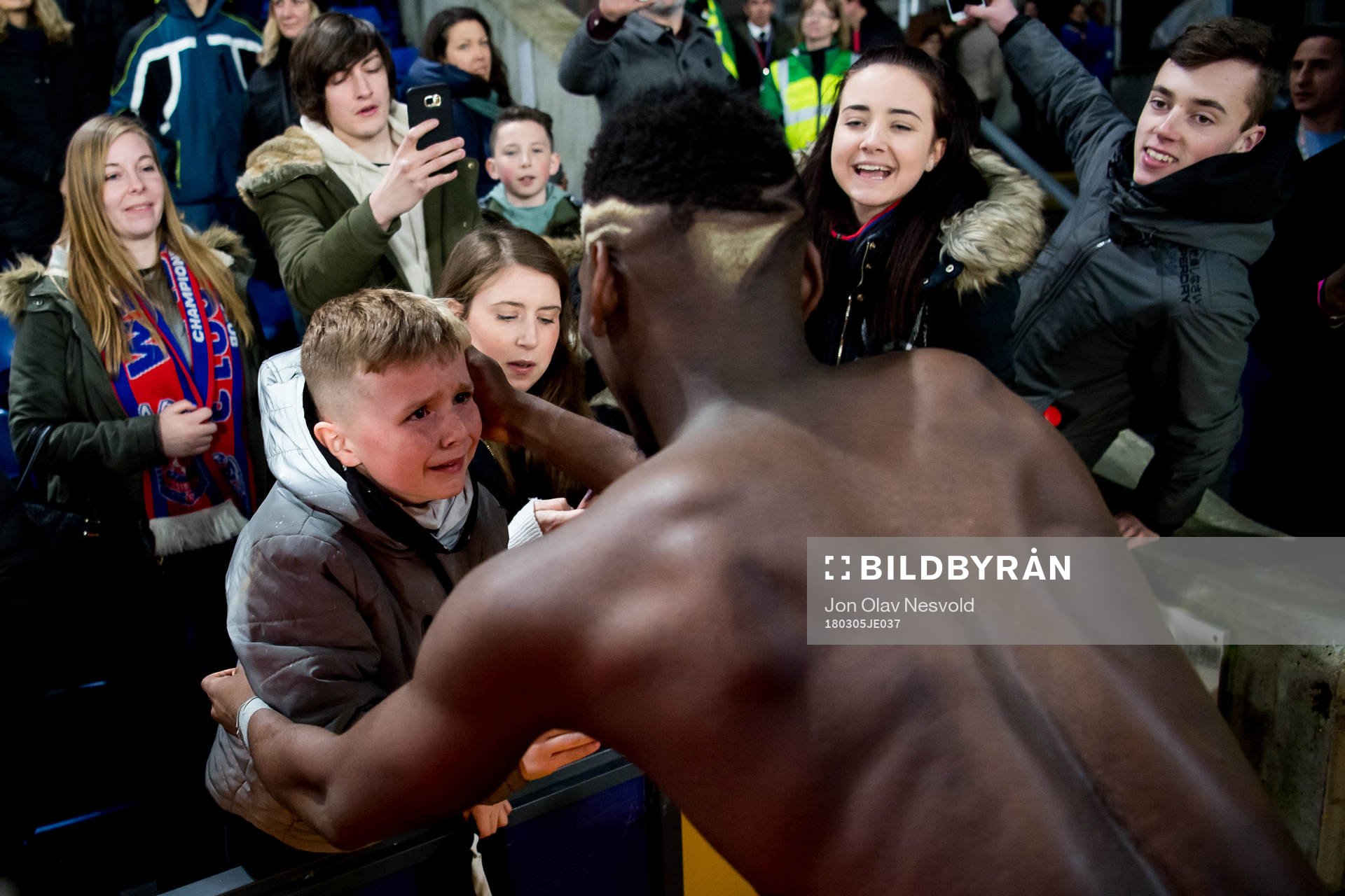 A boy cries when meeting Paul Pogba of Manchester United