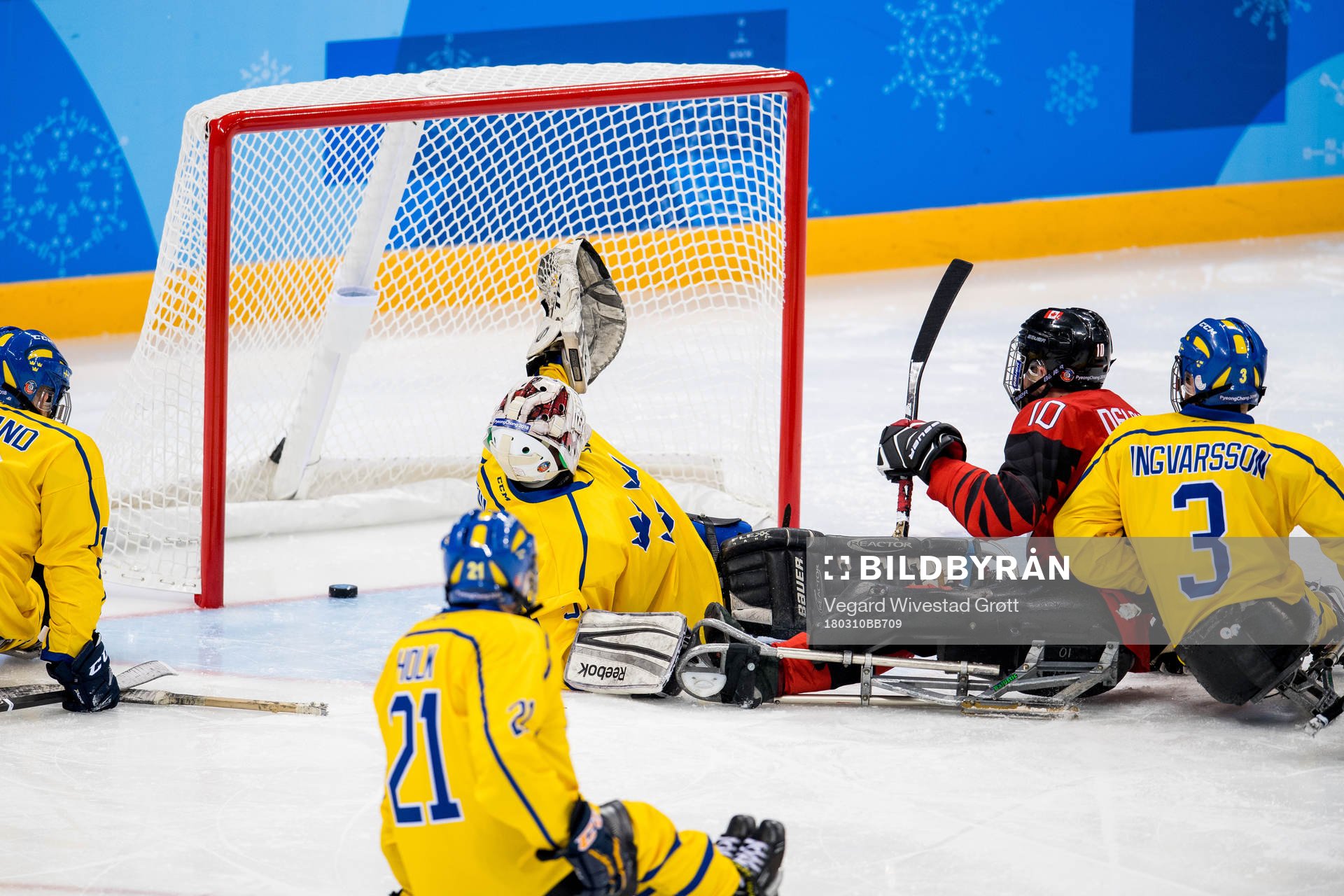 Ben Delaney of Canada scores a goal behind goaltender Ulf