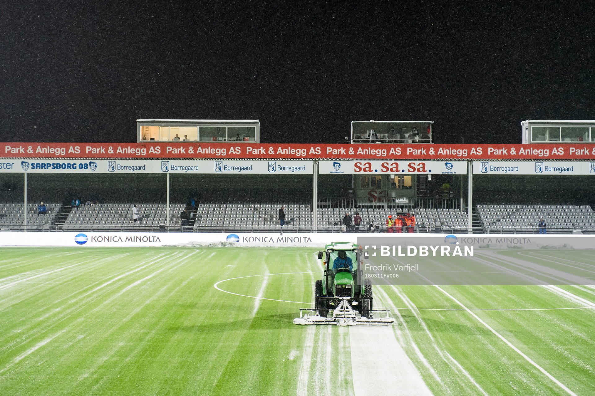 A tractor clean the field for snow