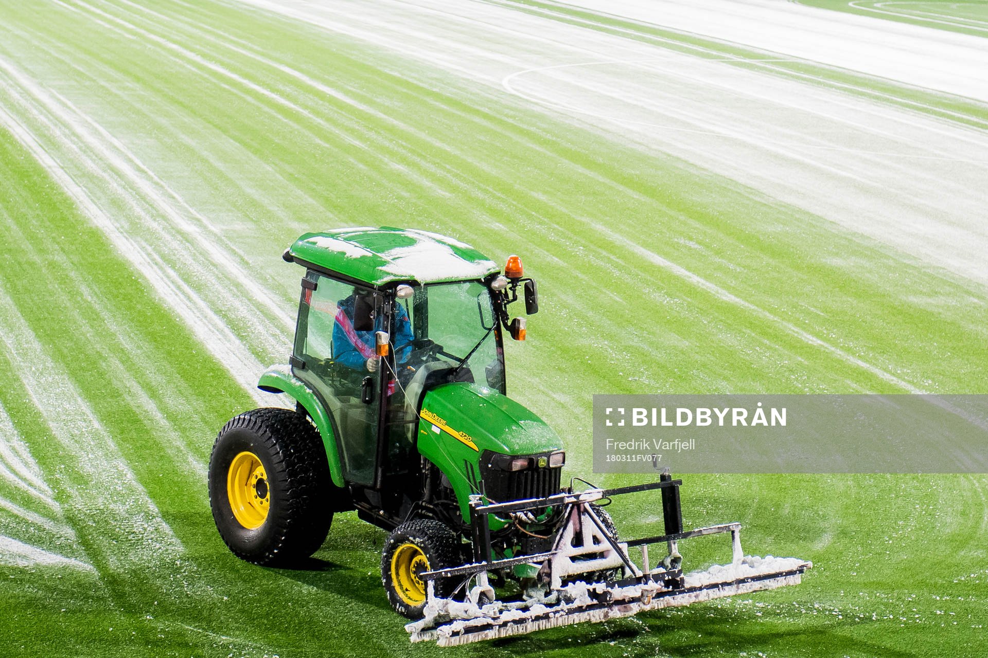 A tractor clean the field for snow