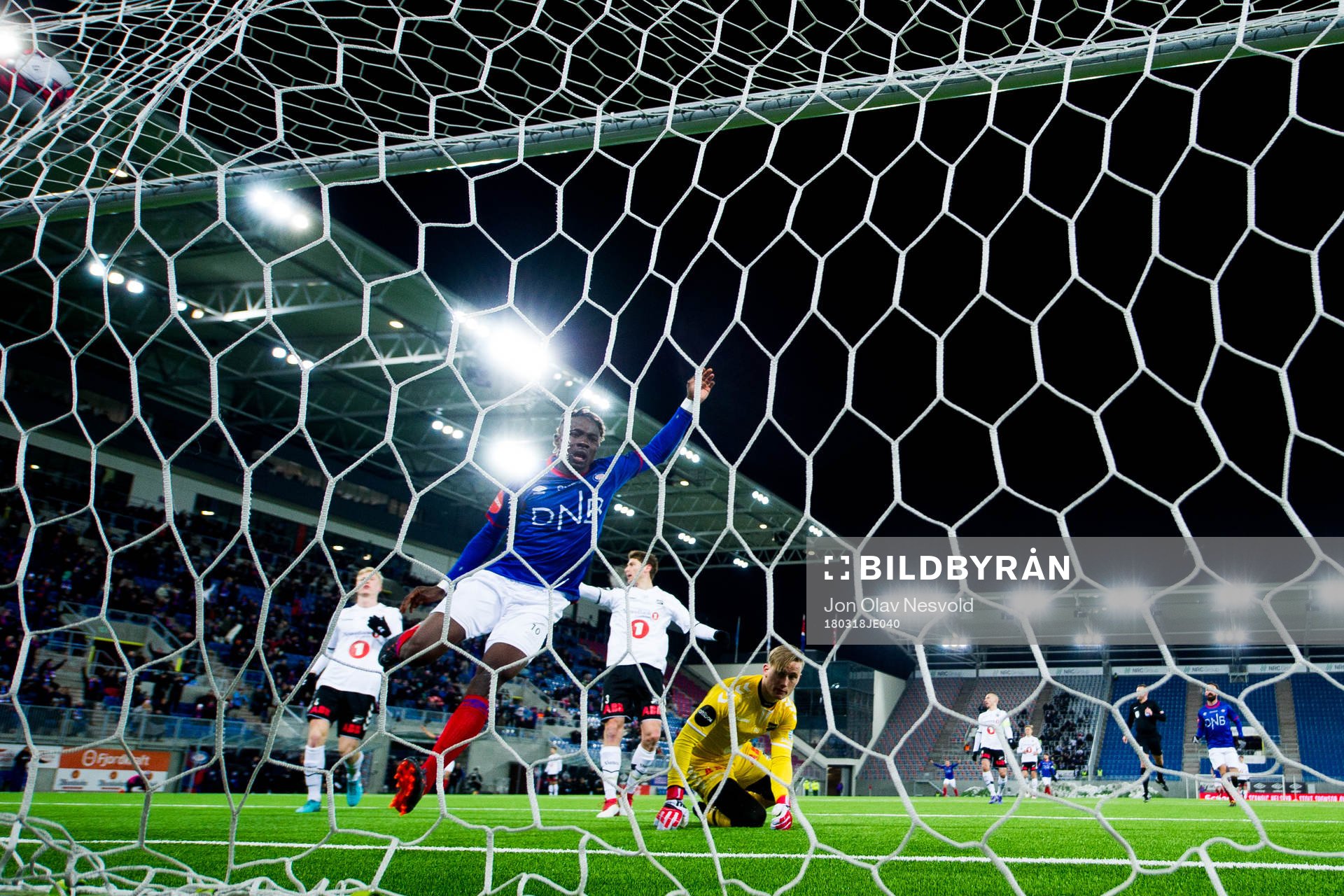 Sam Johnson of Vålerenga scores 2-1 behind goalkeeper Sondre Løvseth Rossbach of Odd during the Eliteserien match between Vålerenga and Odd on March 18, 2018 in Oslo.