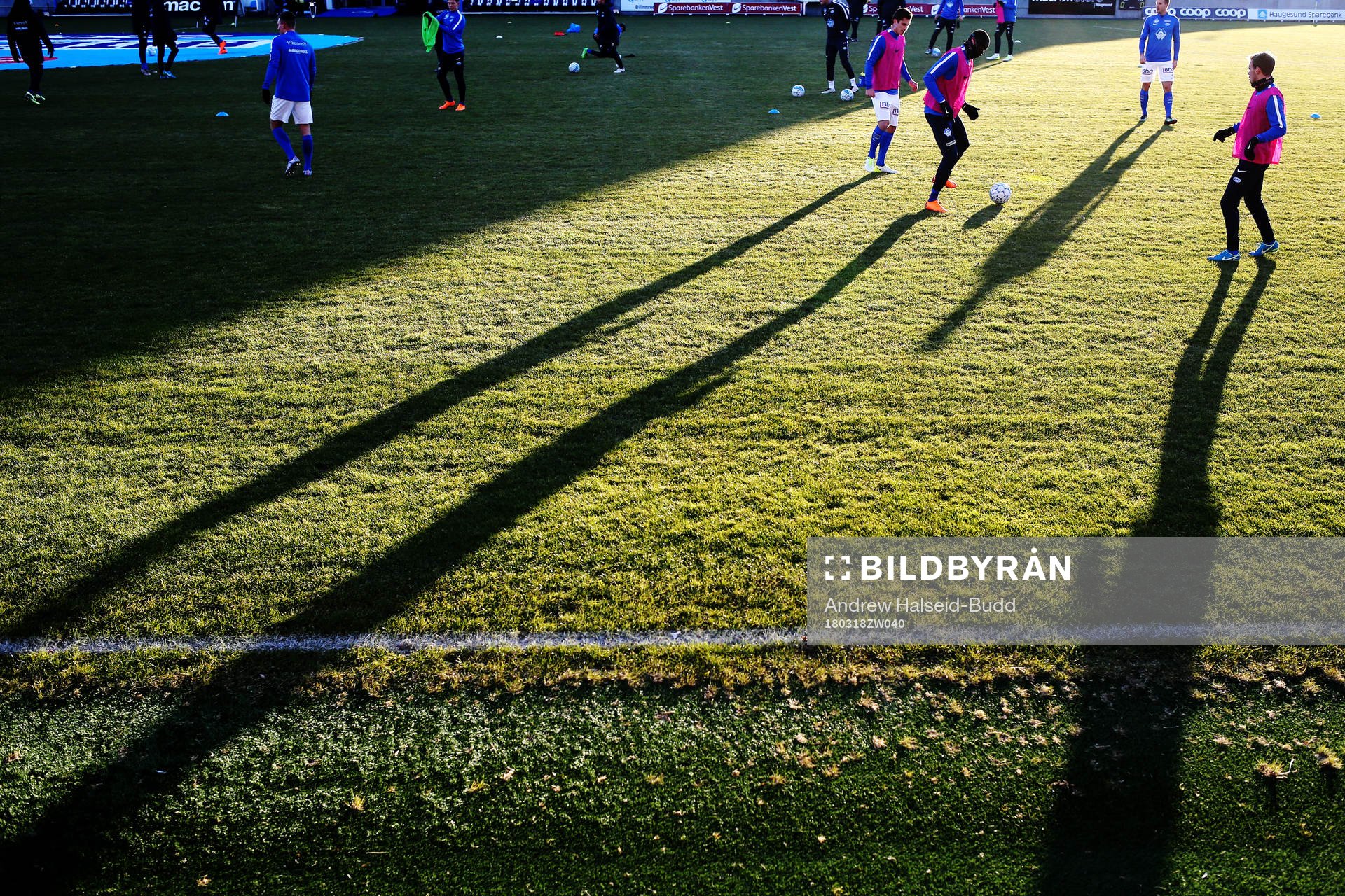 Shadows are seen as the players from Molde warm-up