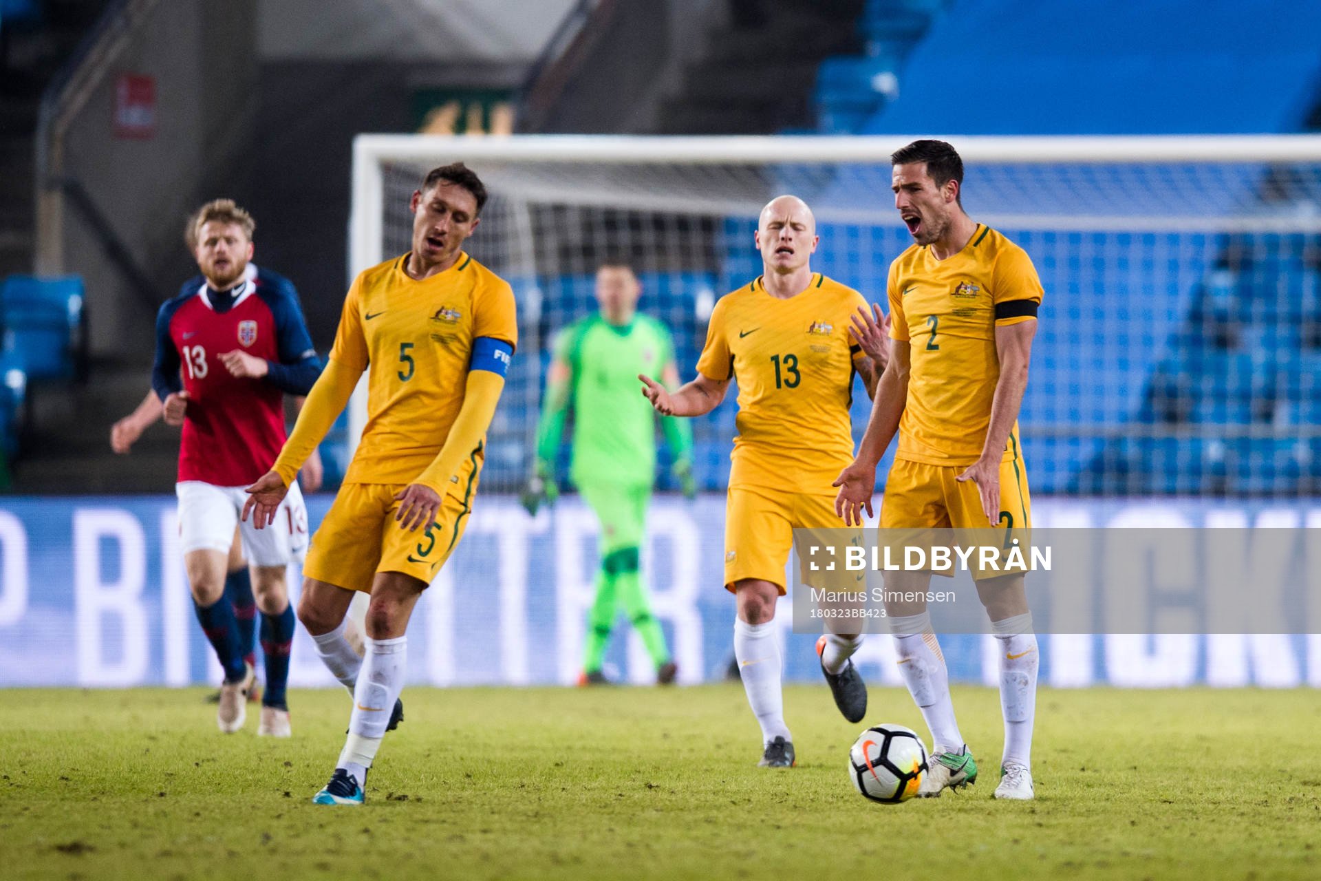 Mark Milligan, Aaron Mooy and Milos Degenek of Australia
