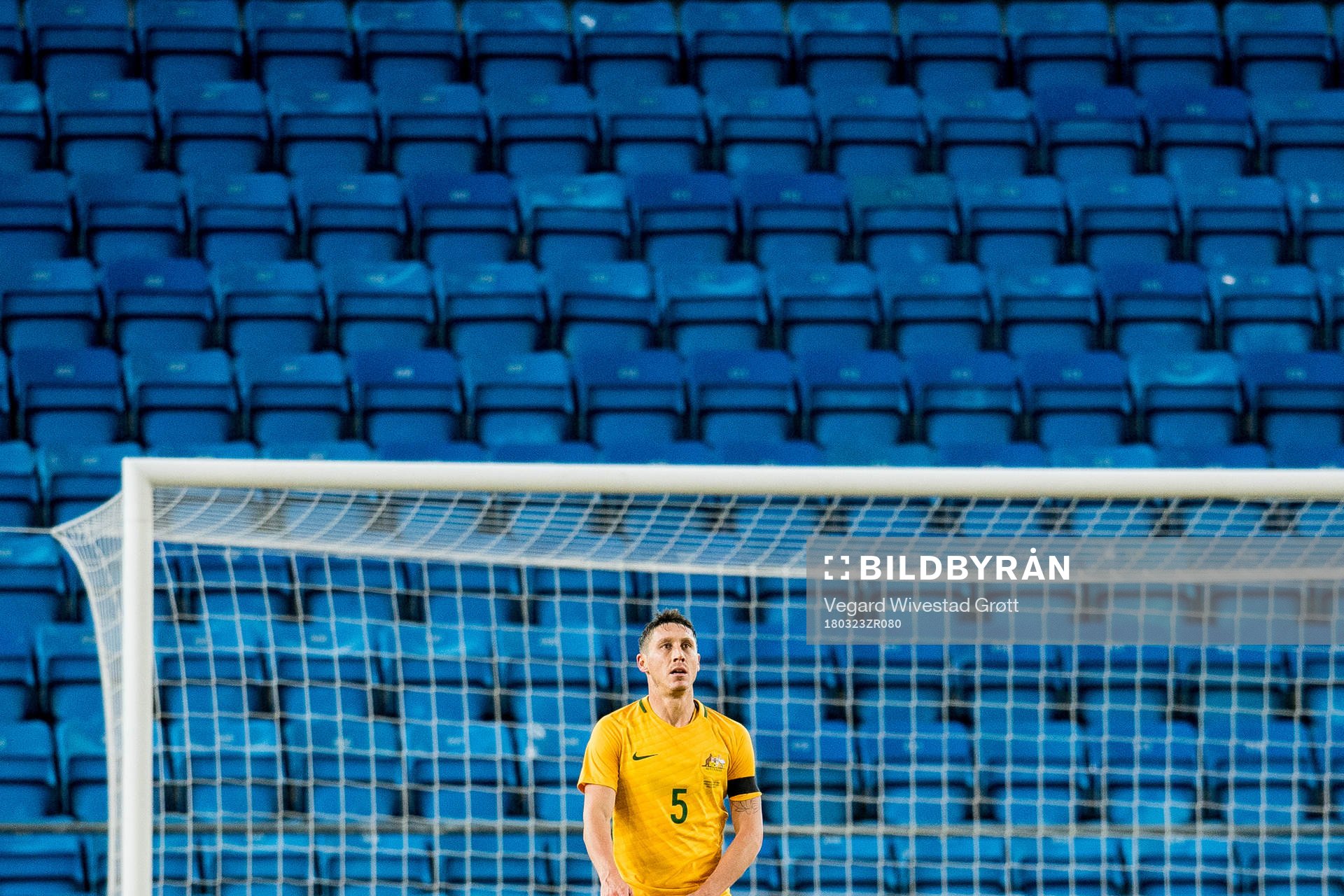 Mark Milligan of Australia looks dejected
