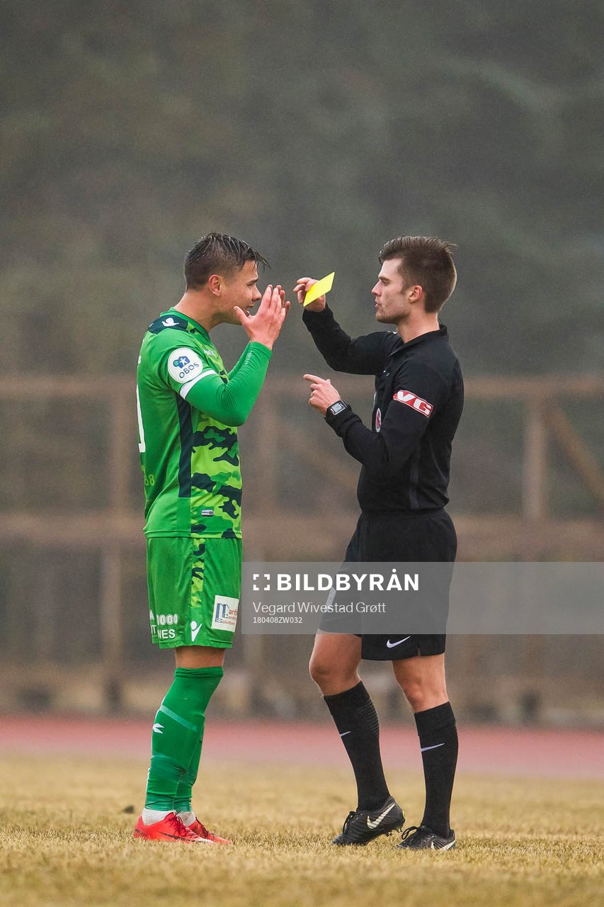 Alexander Dang of Nest-Sotra is shown a yellow card by
