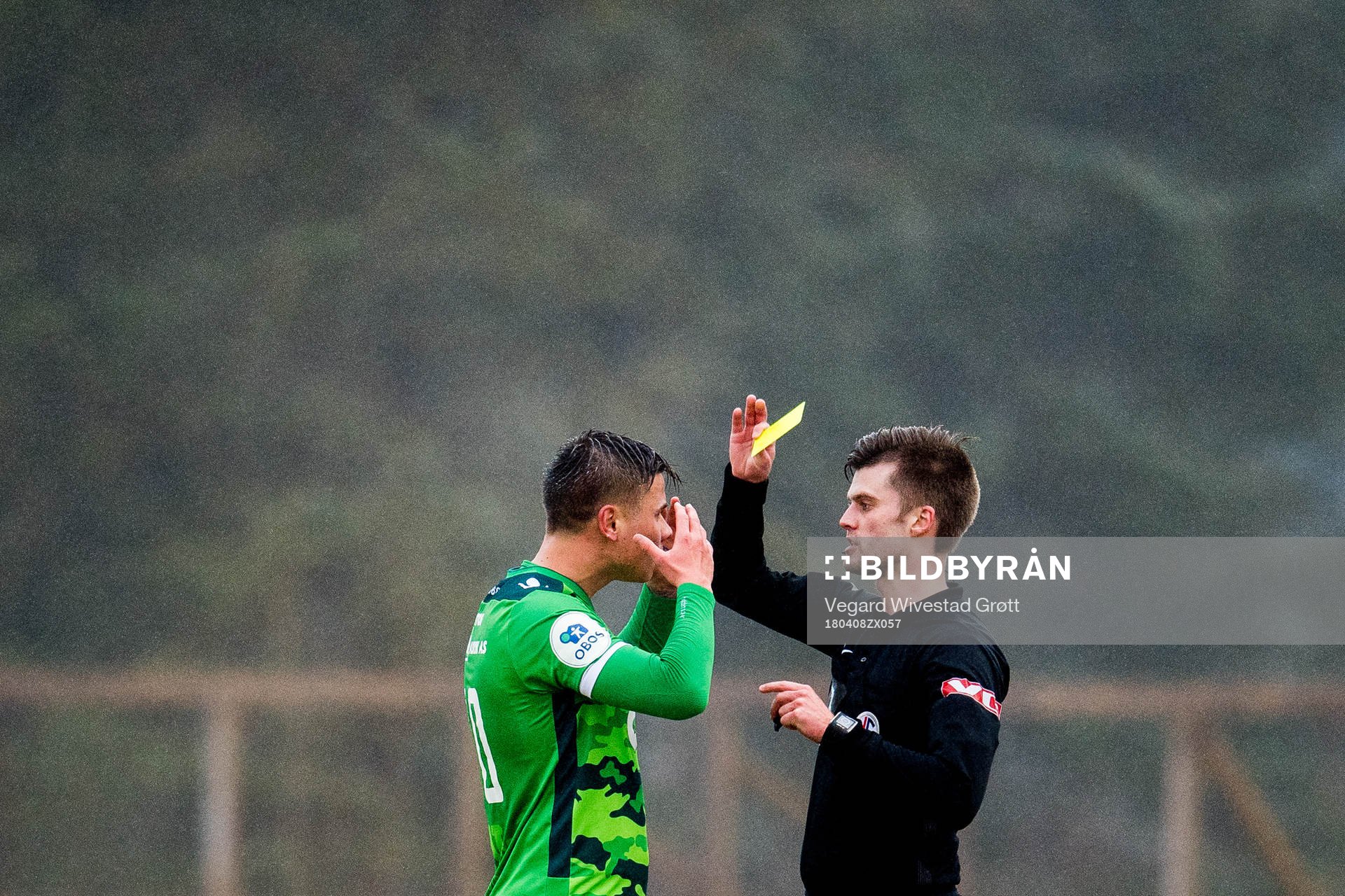 Alexander Dang of Nest-Sotra is shown a yellow card by