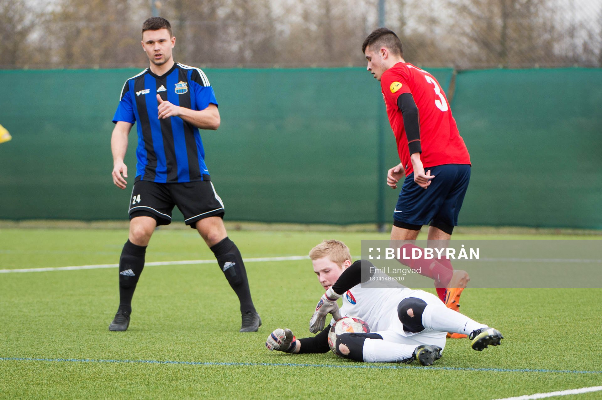 Lilla Torgs  Dennis Karlsson, Bjärreds målvakt Hampus Lövkvist och Lucas El-Dabh Johansson under fotbollsmatchen i division 4 sydvästra mellan Bjärred och Lilla Torg den 14 april 2018  i Bjärred.