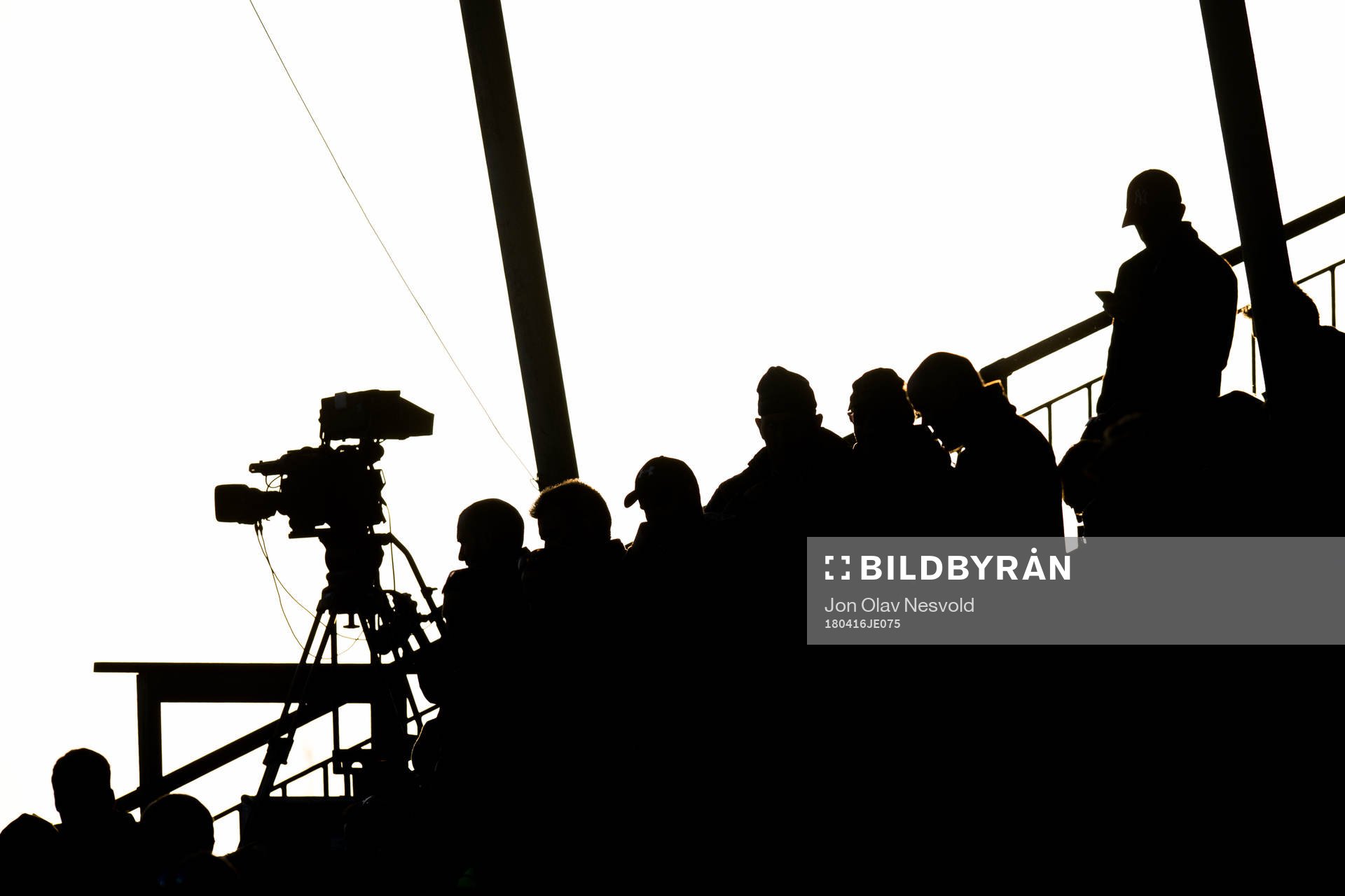 Spectators and a TV camera