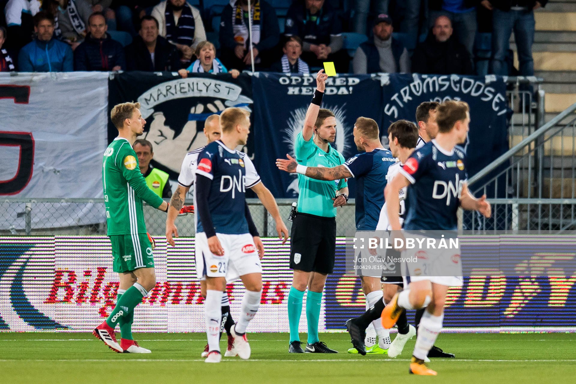Marcus Pedersen of Strømsgodset is shown a yellow card by
