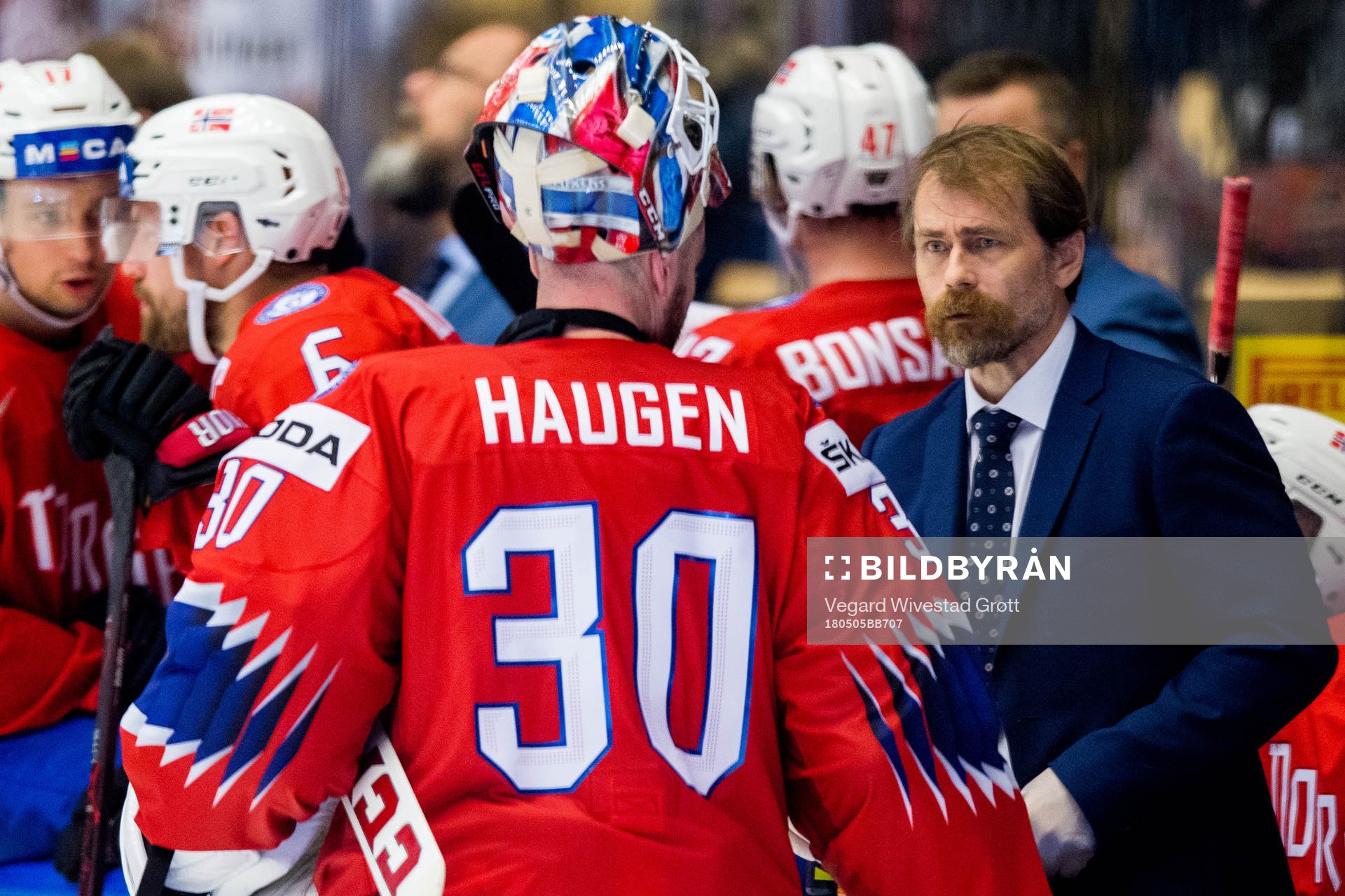 Ole Fosse, team doctor of Norway, talks to goaltender Lars