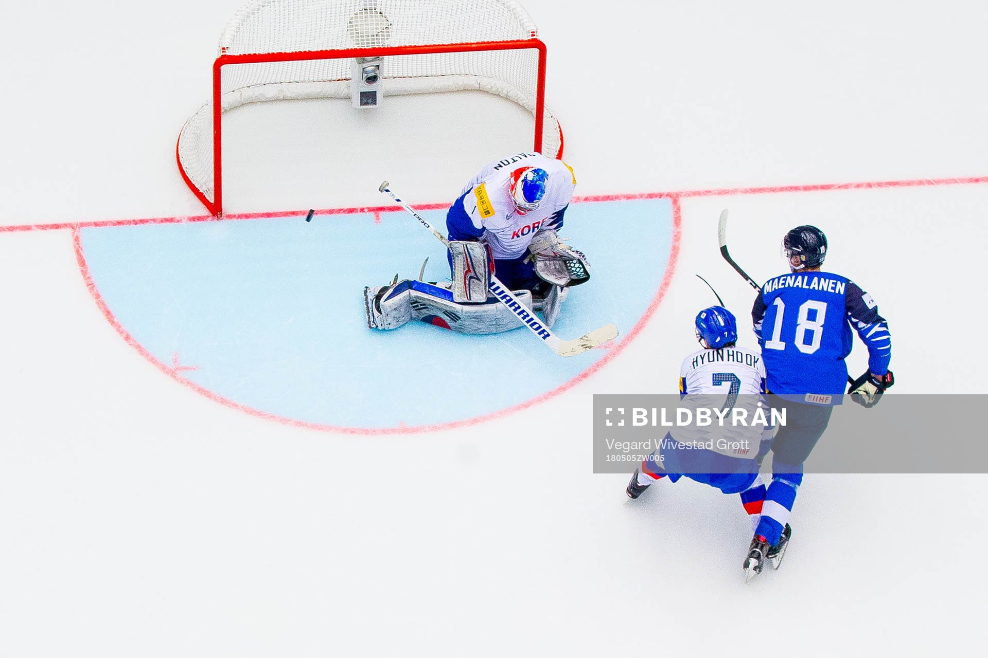 Saku Maenalanen of Finland shoots past Hyonho Oh and