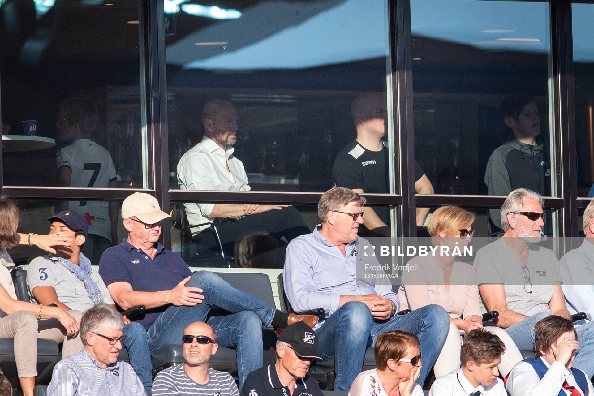 Mark Dempsey, head coach of Start, is seen behind the glass
