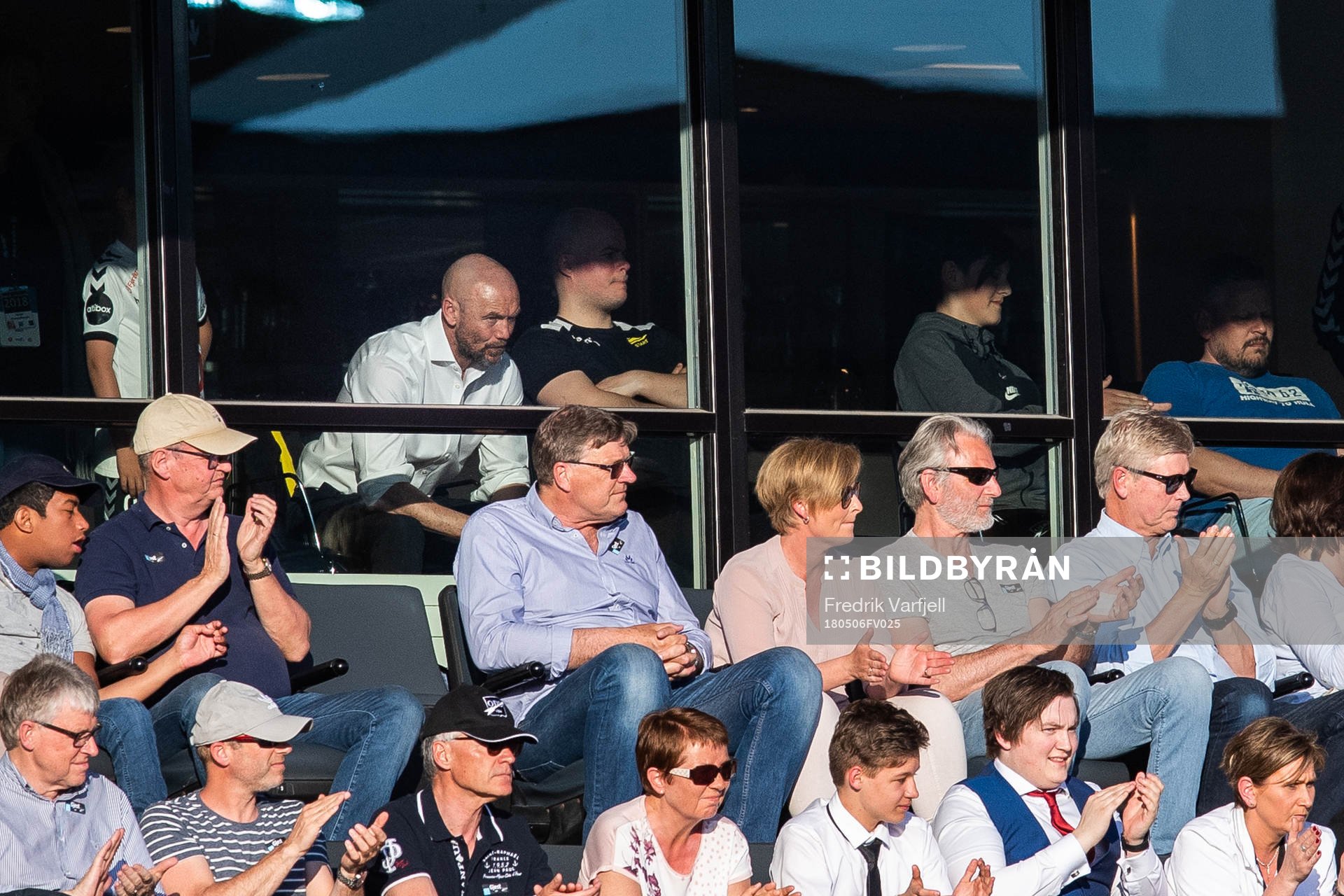 Mark Dempsey, head coach of Start, is seen behind the glass