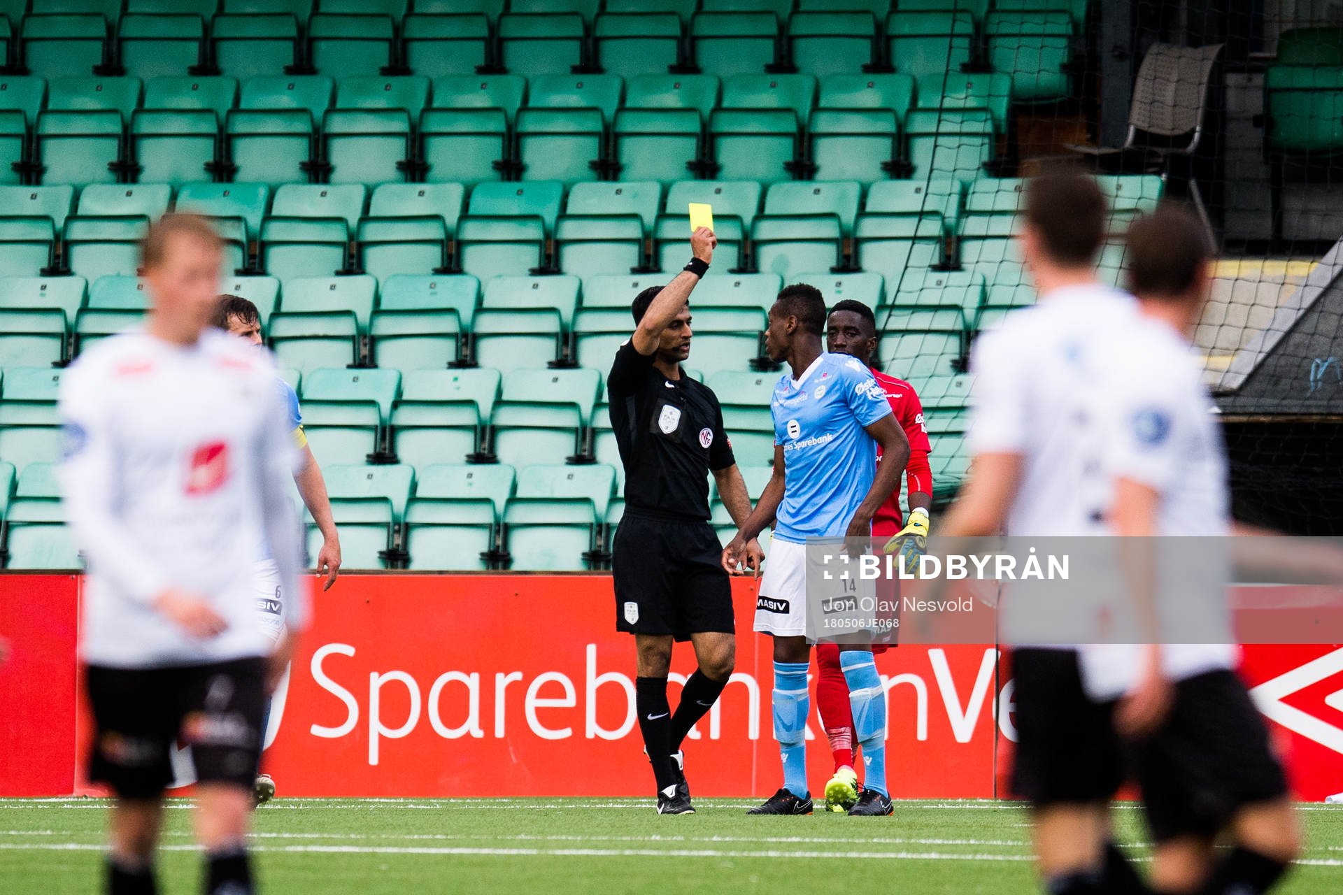Akinsola Akinyemi of Sandnes Ulf is given a yellow card by