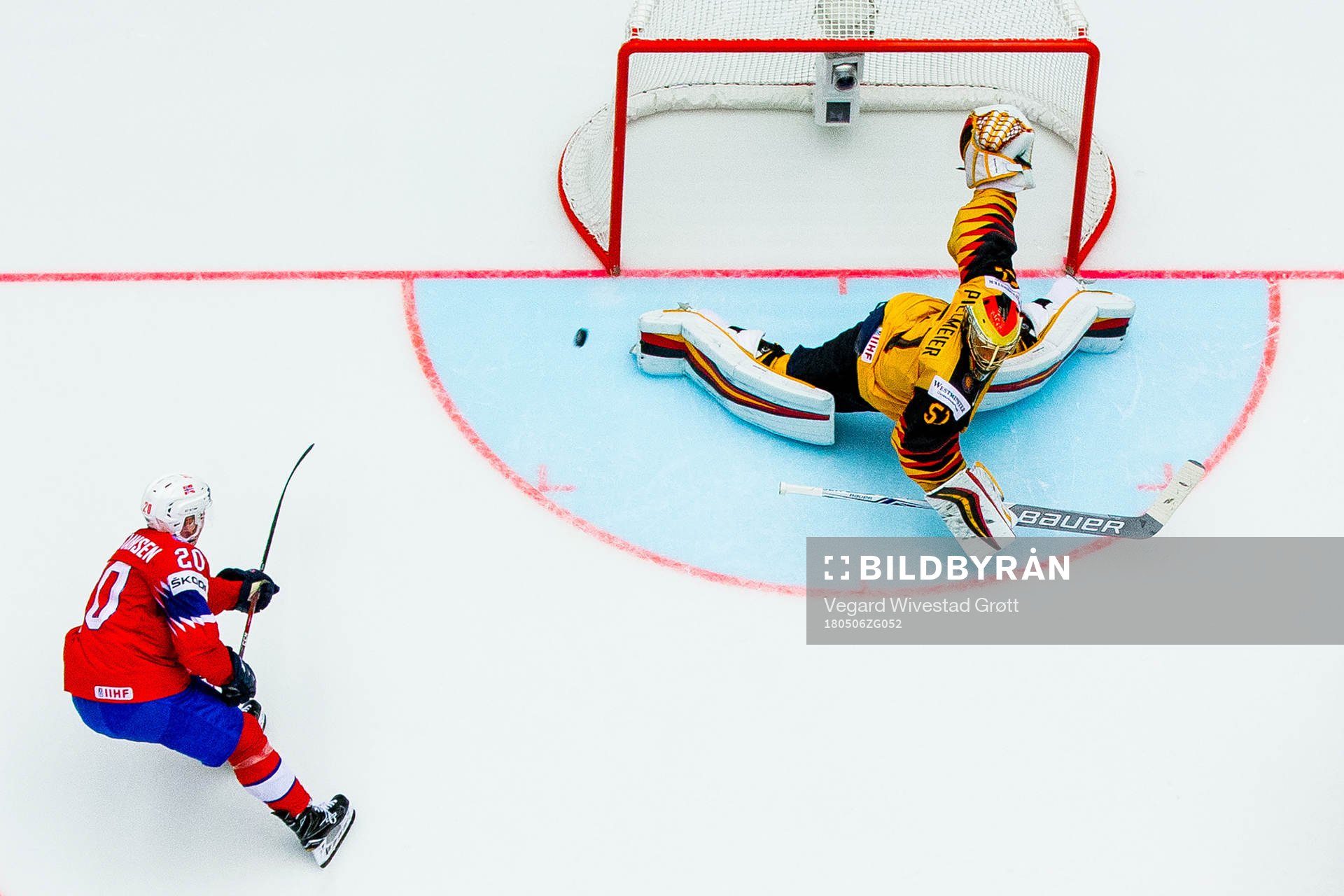 Anders Bastiansen of Norway scores 2-3 behind goaltender