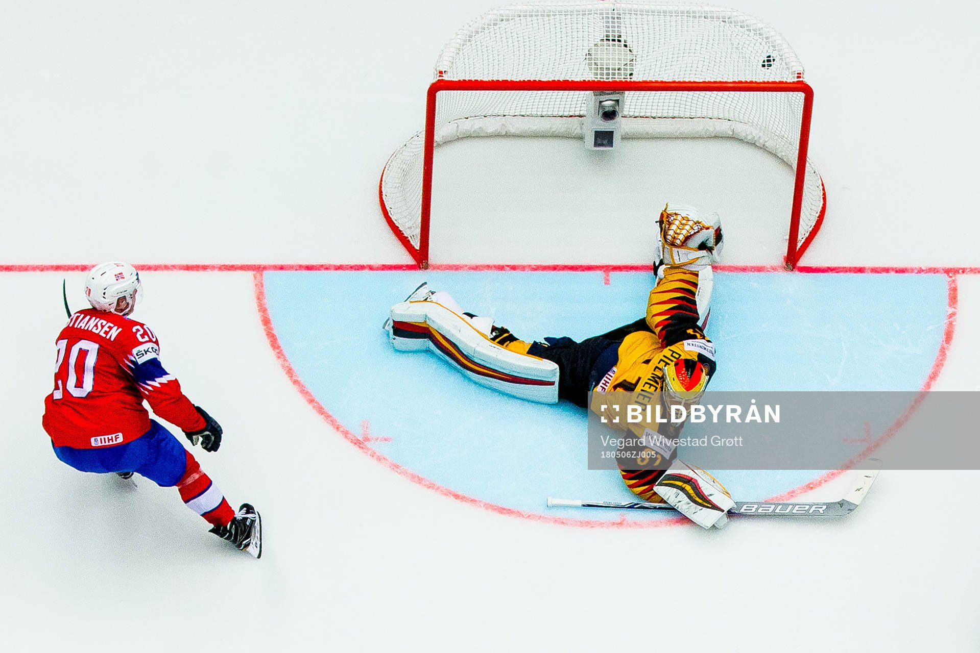 Anders Bastiansen of Norway scores 2-3 behind goaltender