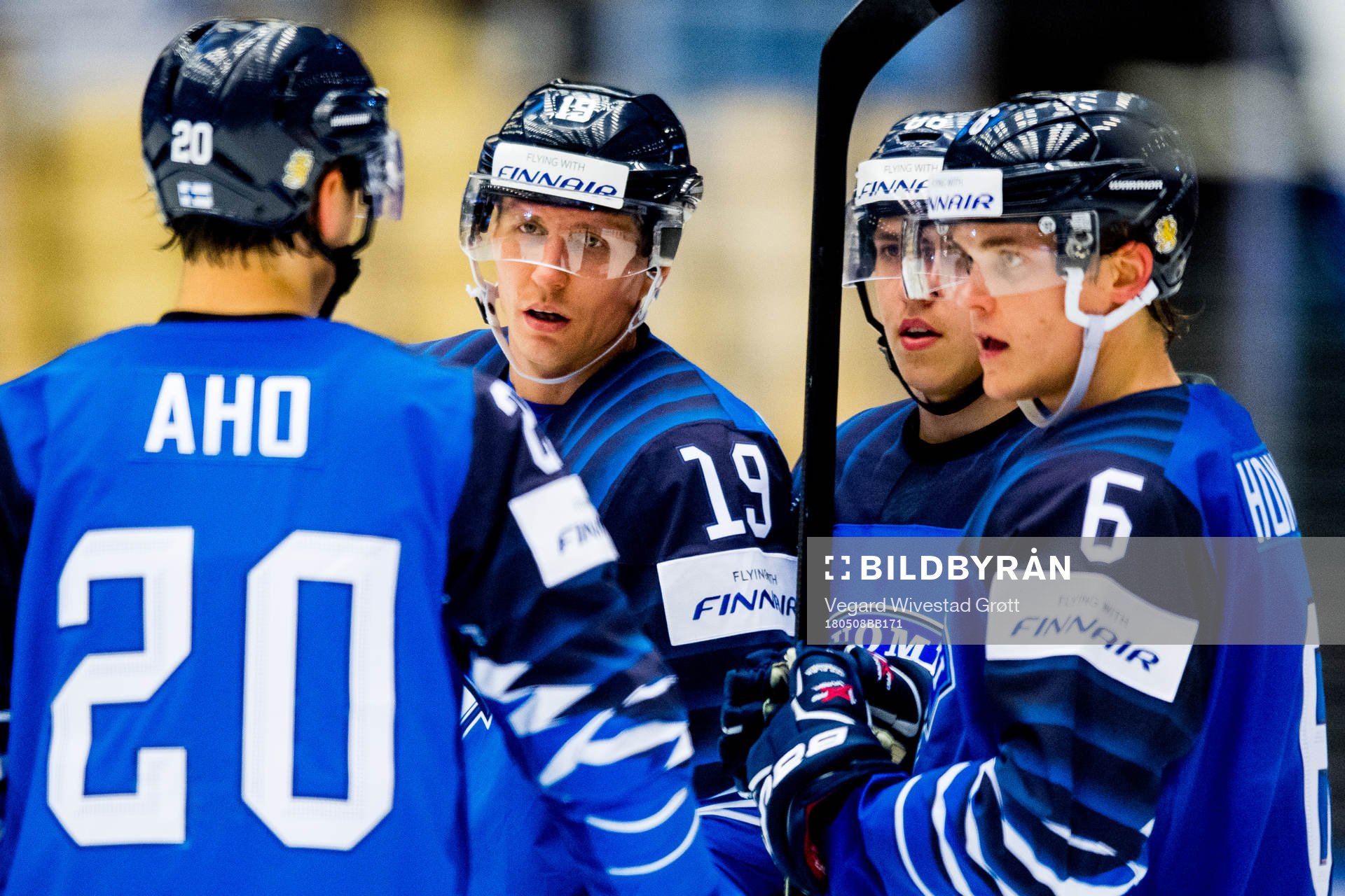 Sebastian Aho talks to teammates Veli-Matti Savinainen,