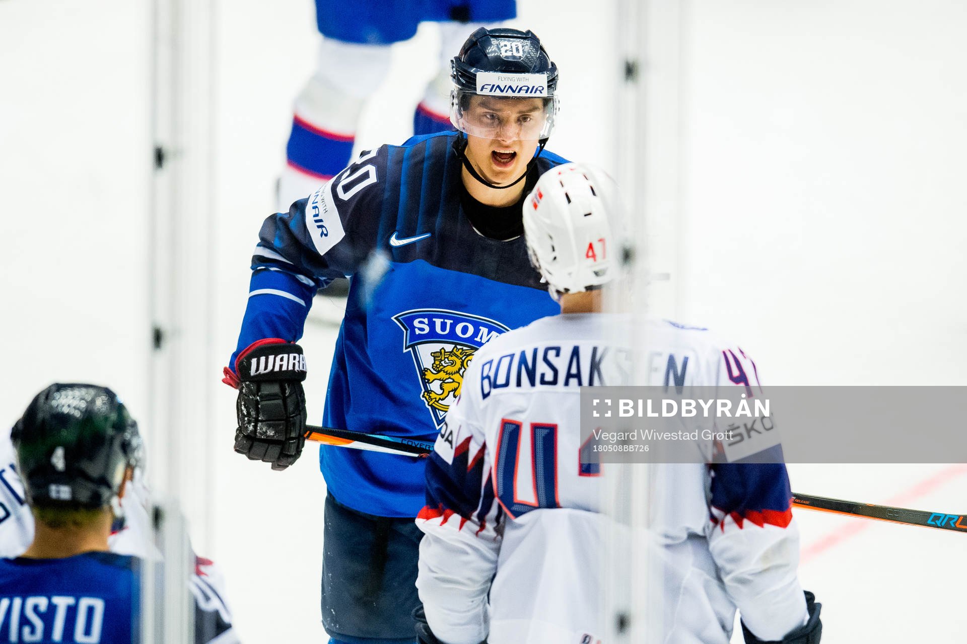 Sebastian Aho of Finland argues with Alexander Bonsaksen of