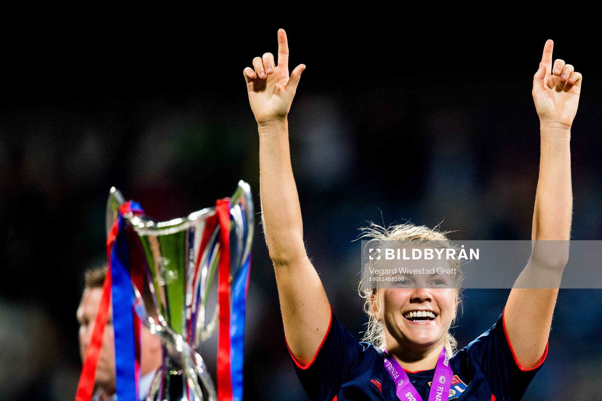 Ada Hegerberg of Lyon celebrates next to the trophy