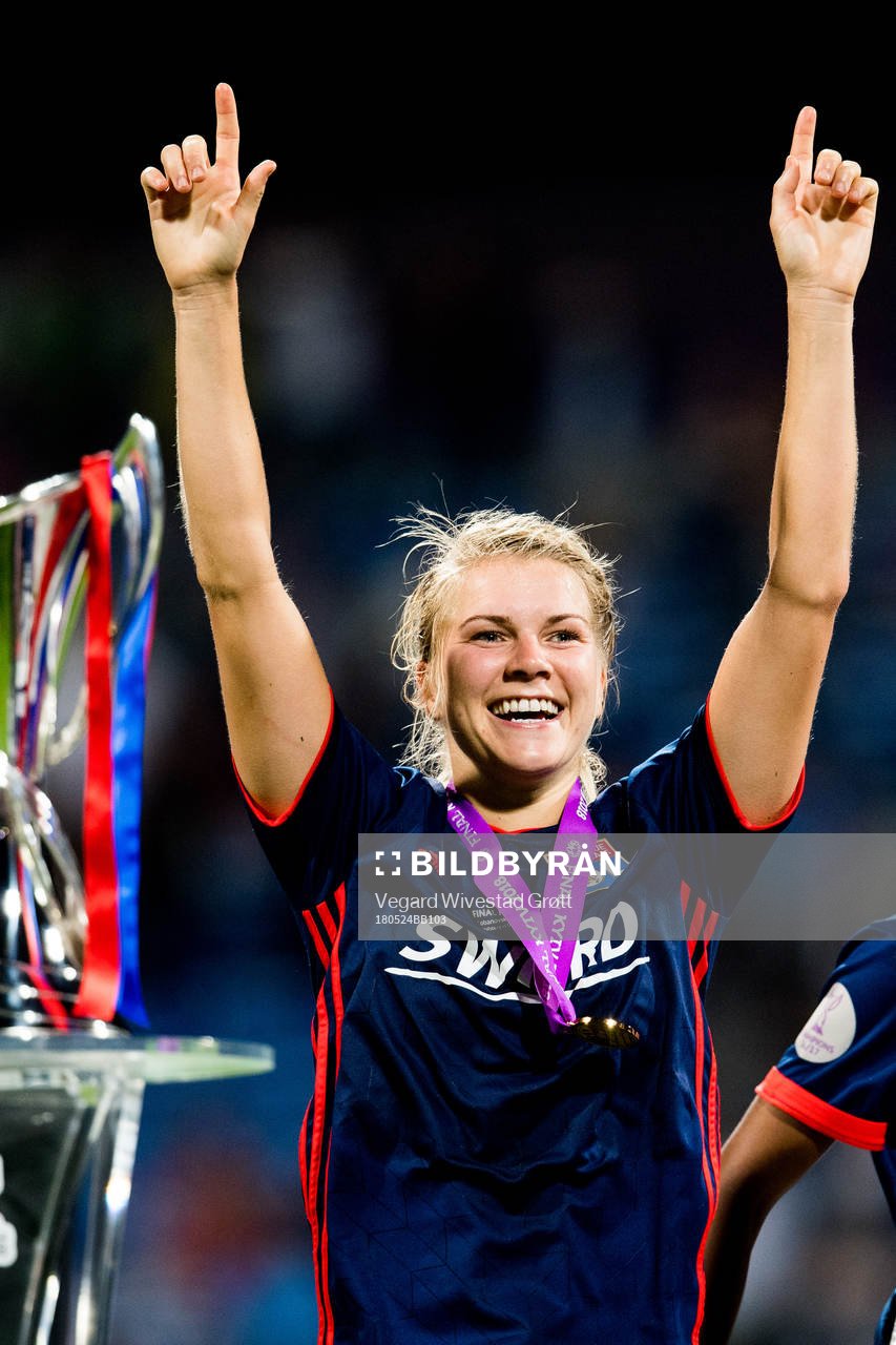 Ada Hegerberg of Lyon celebrates next to the trophy