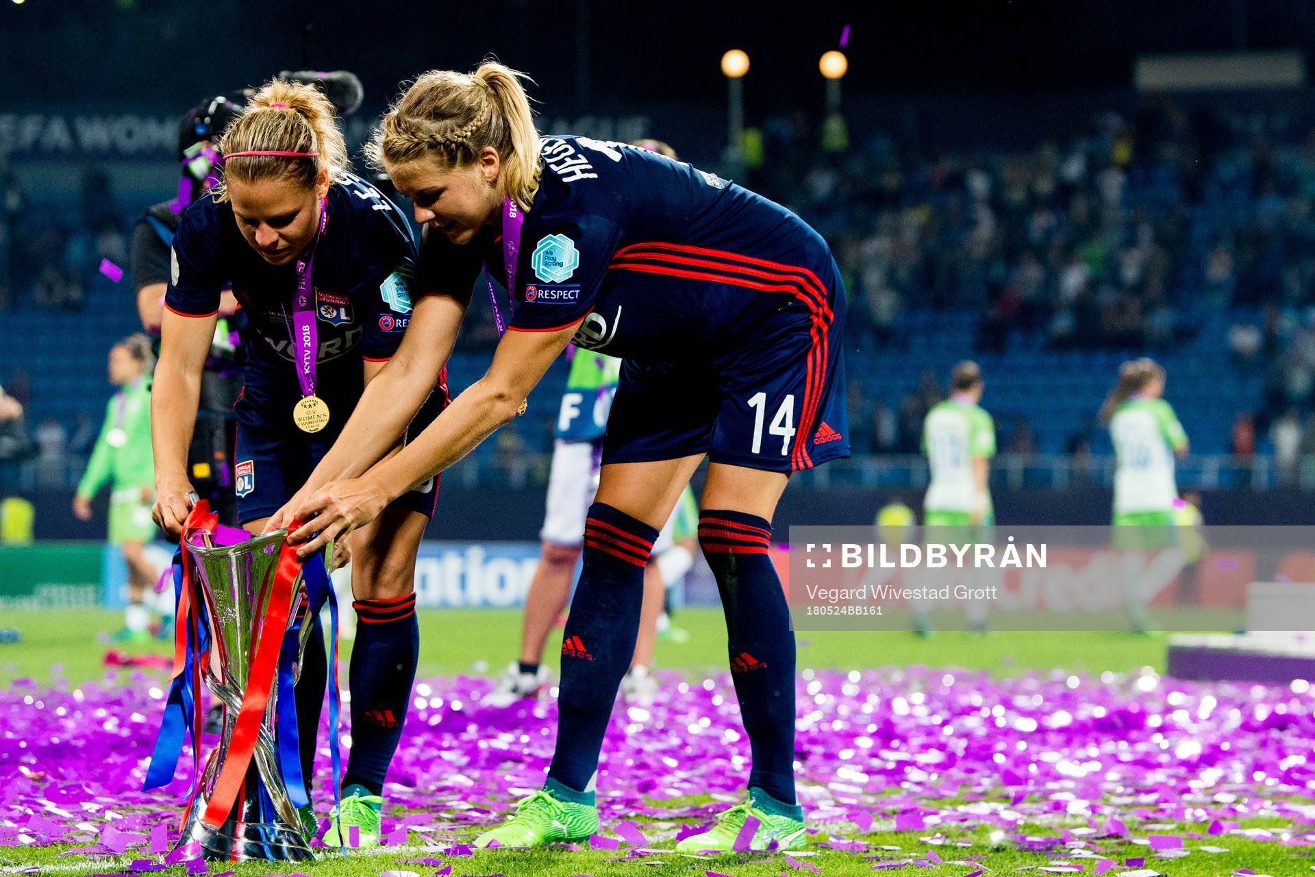 Eugénie Le Sommer and Ada Hegerberg of Lyon with the trophy