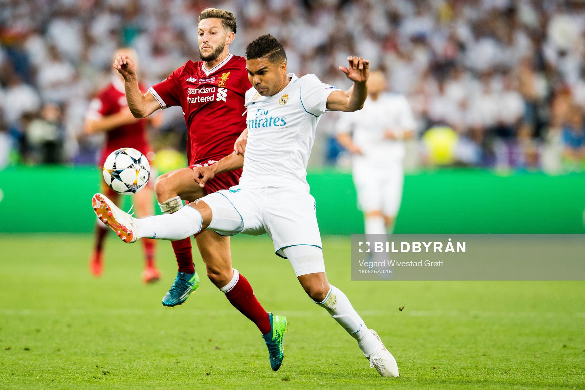 Adam Lallana of Liverpool and Casemiro of Real Madrid