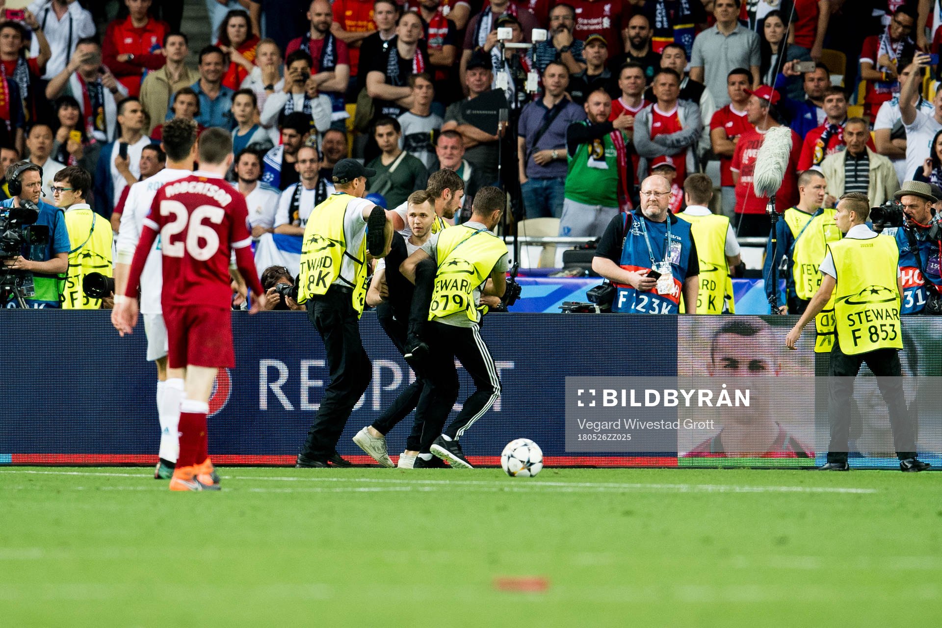 A spectator enters the pitch