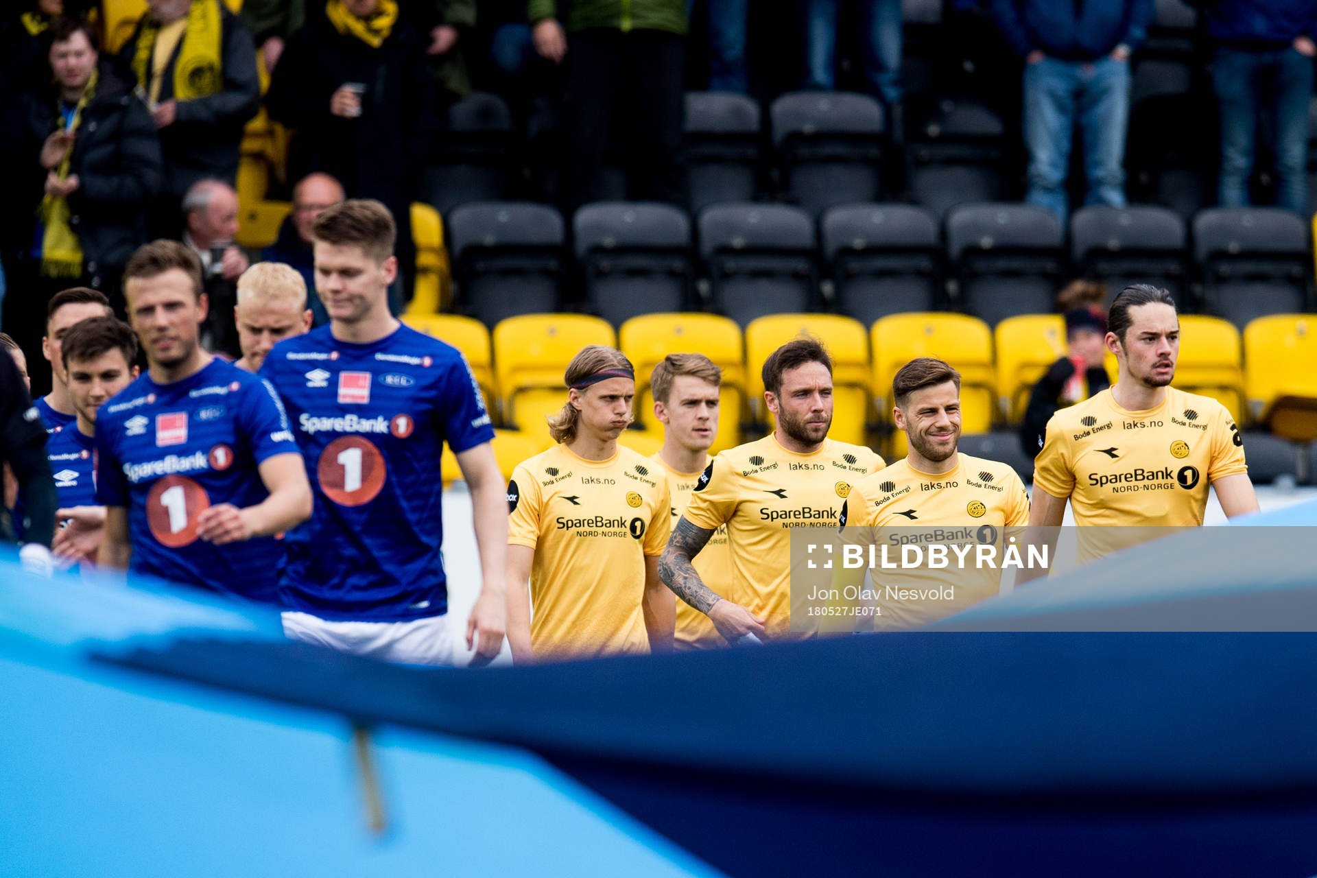 The teams enter the pitch