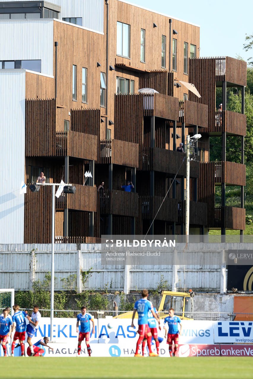 Spectators watch the game from surrounding buildinsg
