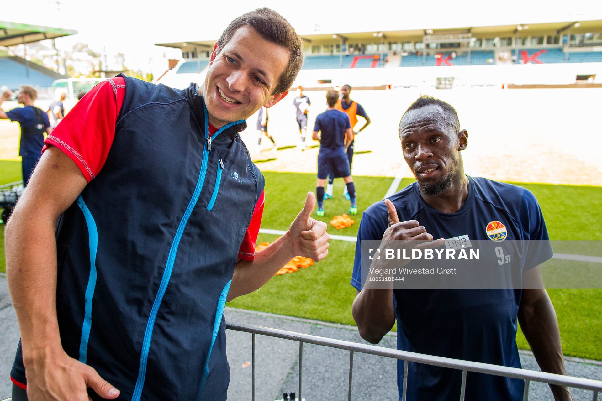Usain Bolt poses for a picture with a fan