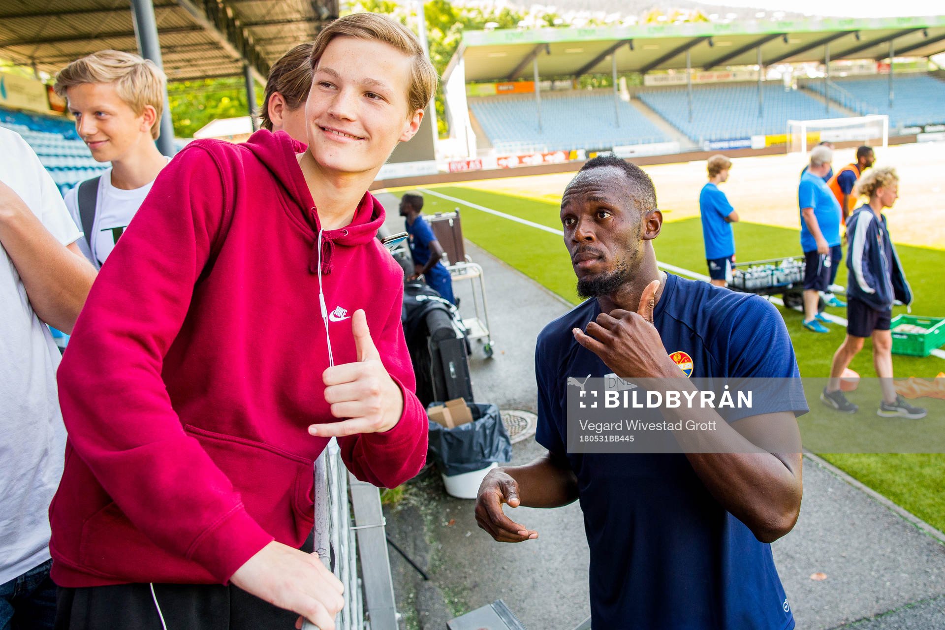 Usain Bolt poses for a picture with a fan