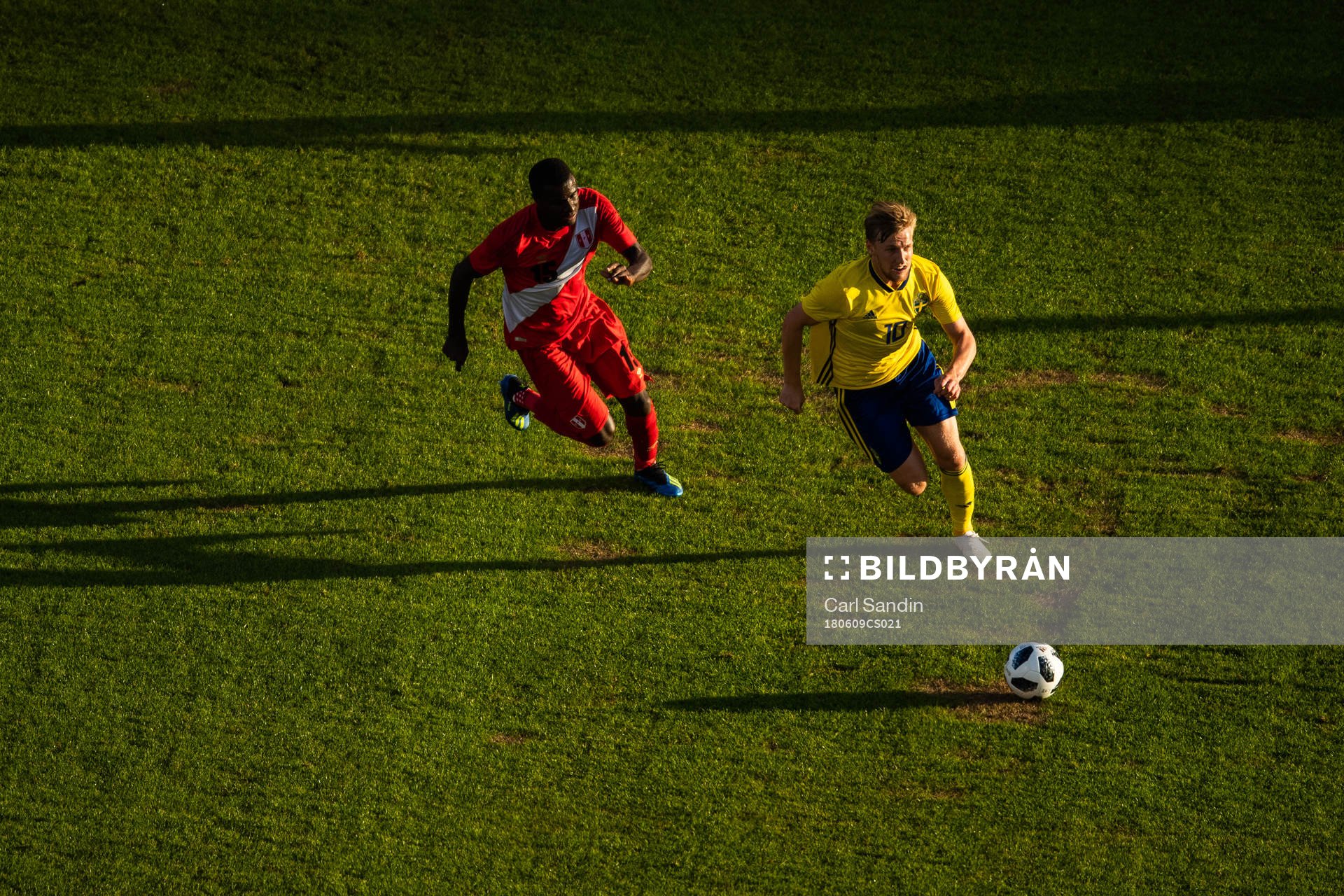 Christian Ramos of Peru chases Marcus Berg of Sweden