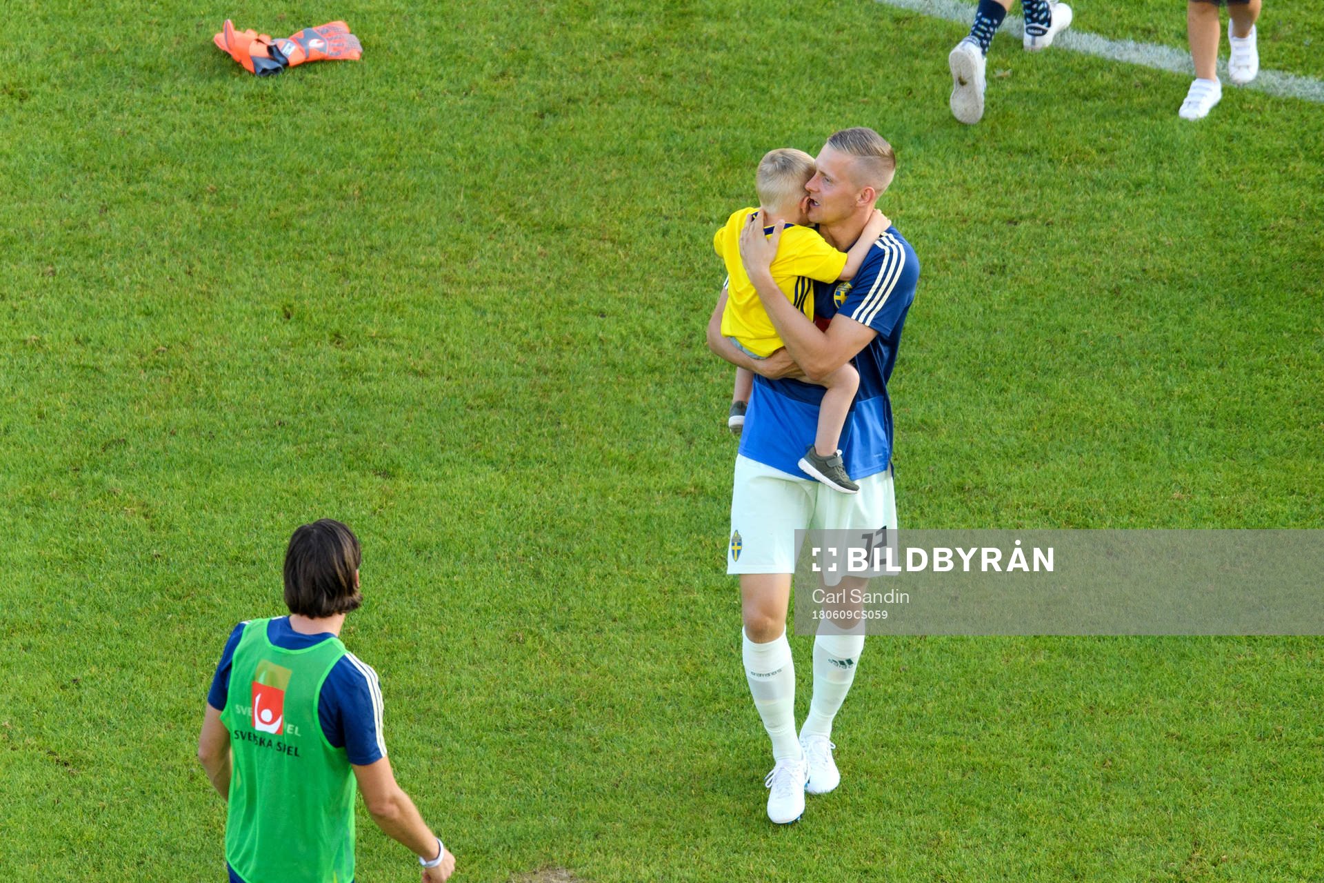 Goalkeeper Karl-Johan Johnsson of Sweden with his child