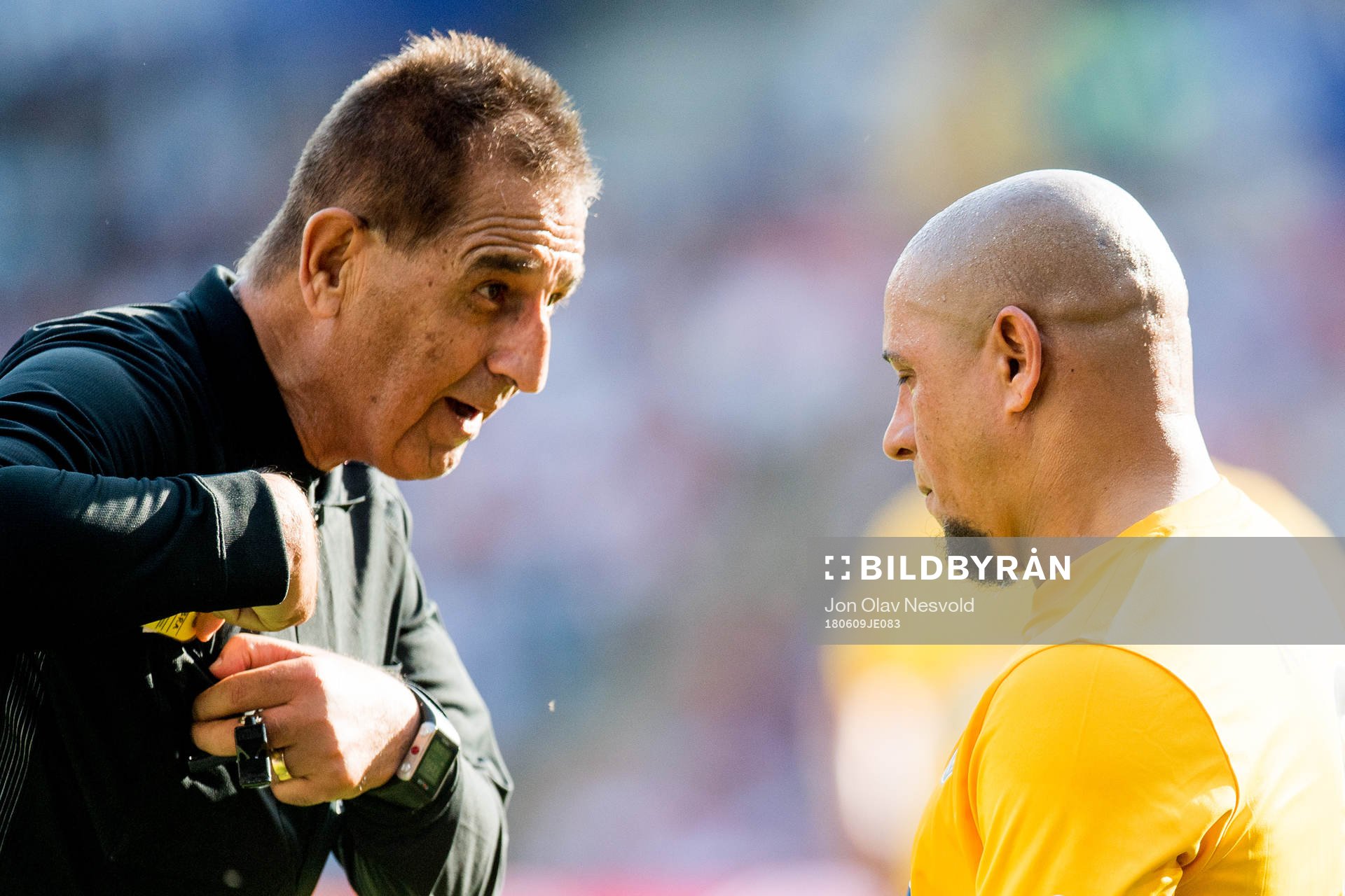 Esse Baharmast, referee, and Roberto Carlos of Brazil