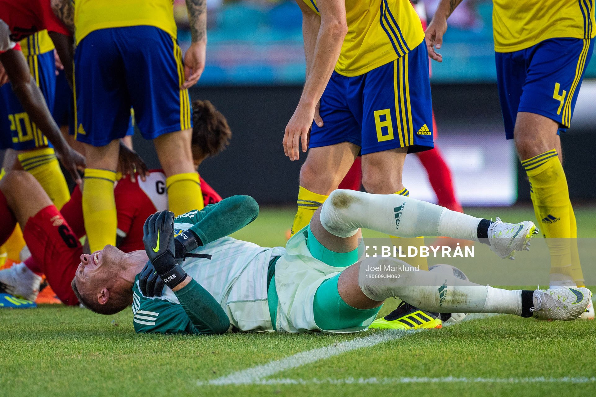 Goalkeeper Robin Olsen of Sweden reaches for his shoulder