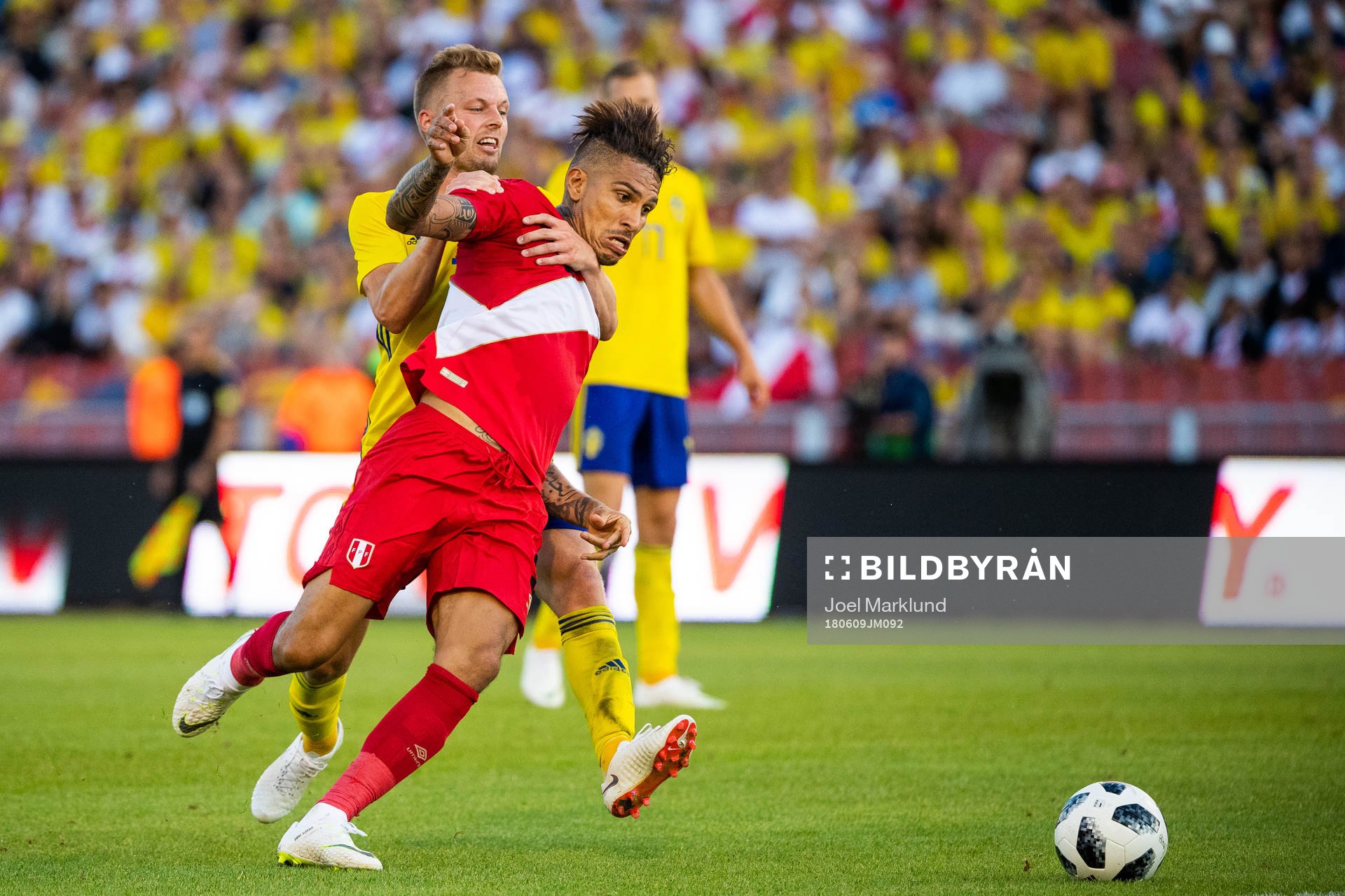Paolo Guerrero of Peru competes for the ball with Sebastian