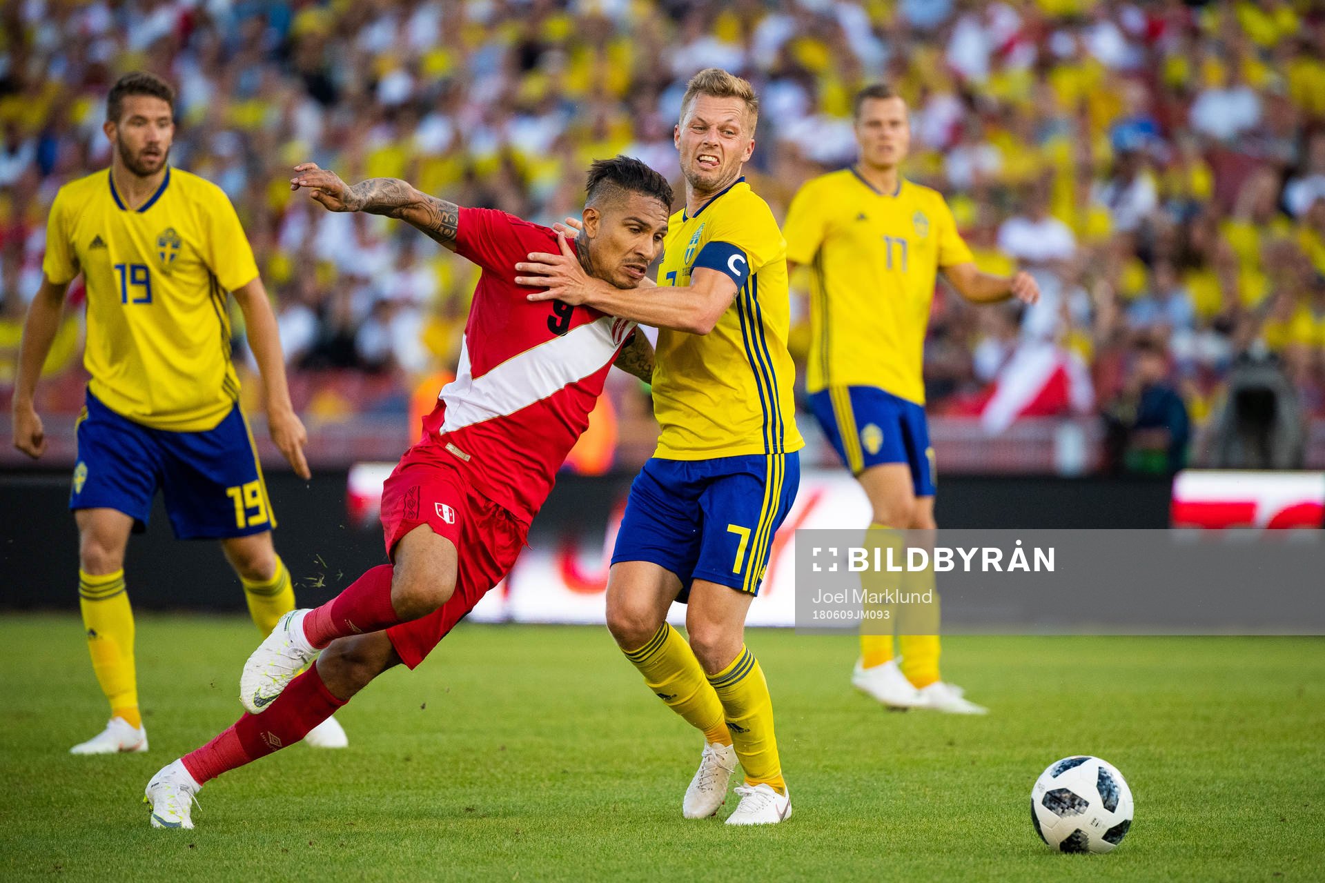 Paolo Guerrero of Peru competes for the ball with Sebastian