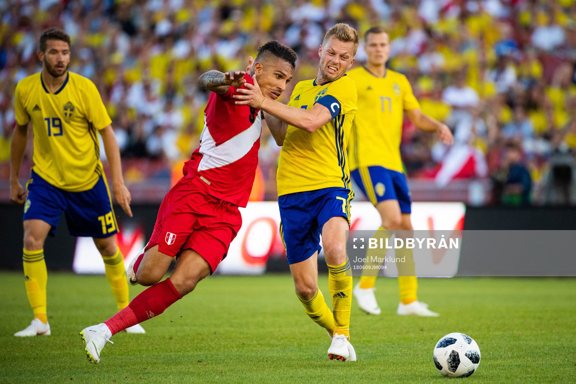 Paolo Guerrero of Peru competes for the ball with Sebastian