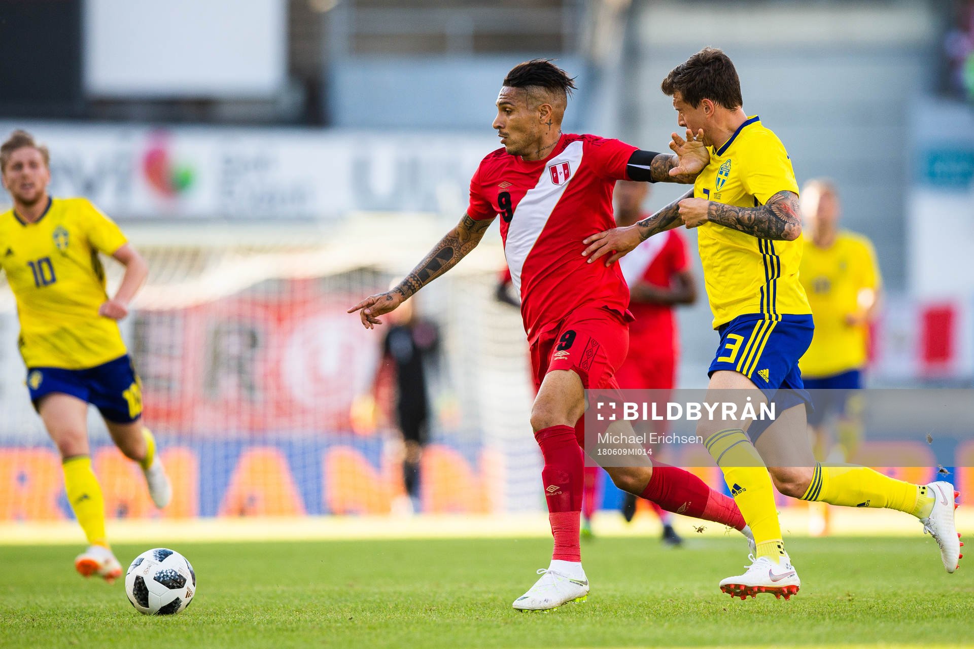 Paolo Guerrero of Peru competes for the ball with Victor