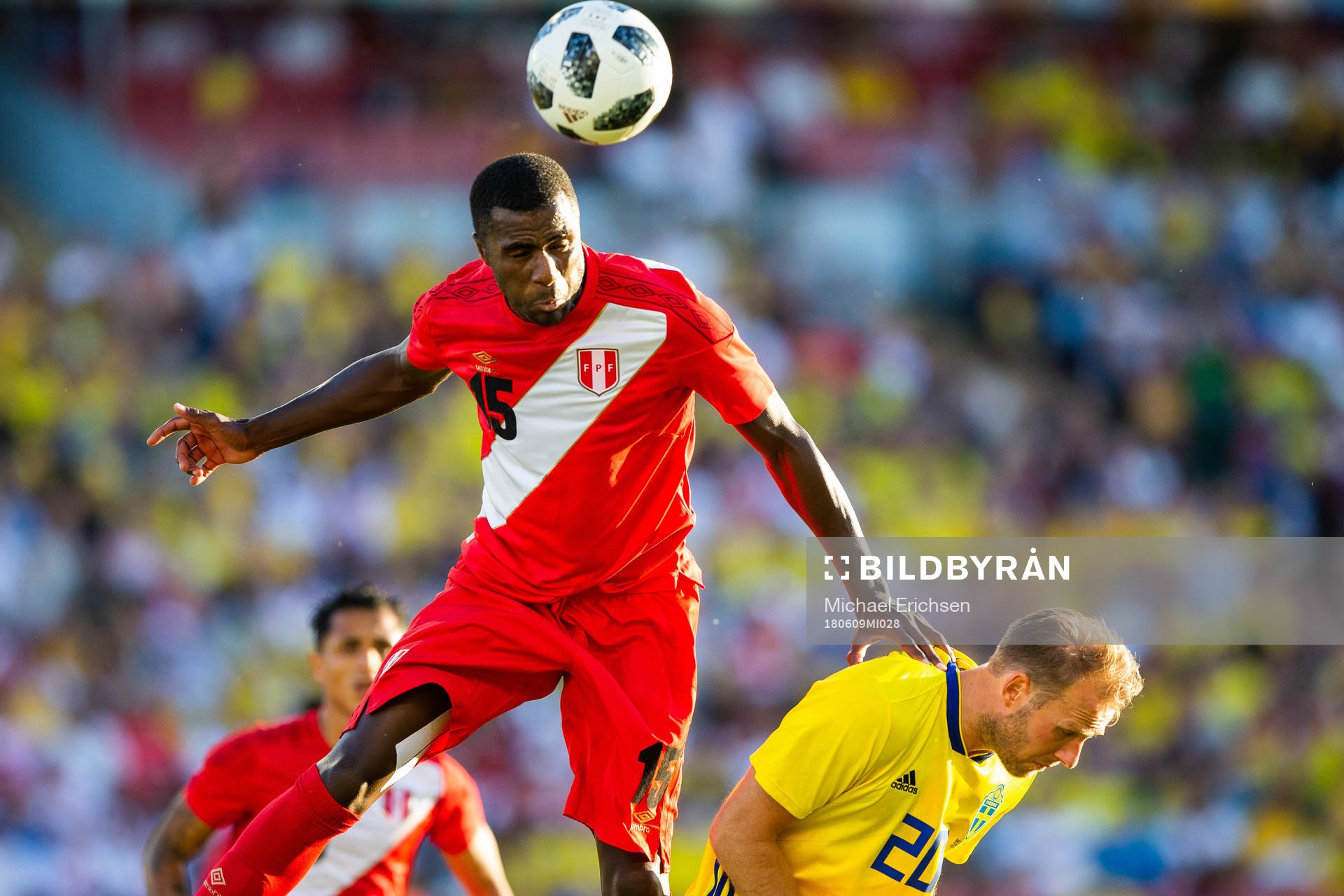 Christian Ramos of Peru wins a header against Ola Toivonen