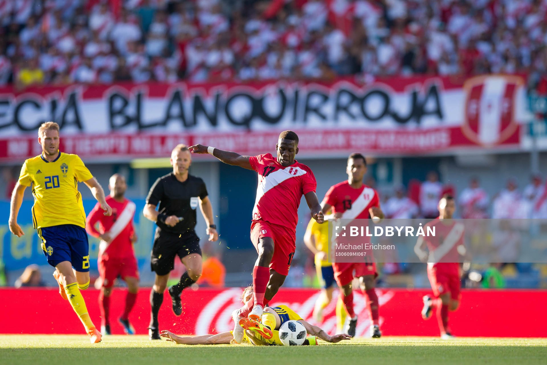 Luis Advincula of Peru avoids a tackle from Albin Ekdal of