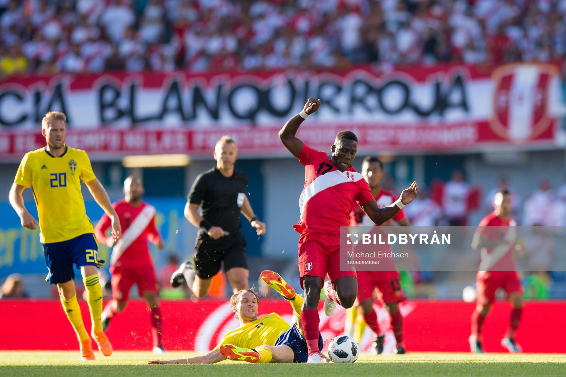 Luis Advincula of Peru avoids a tackle from Albin Ekdal of