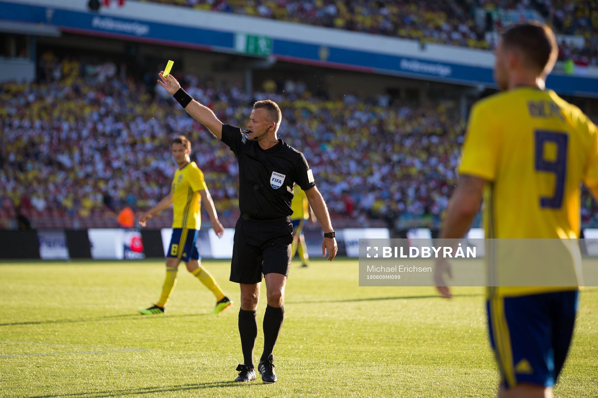Referee  Svein Oddvar Moen showing a yellow card